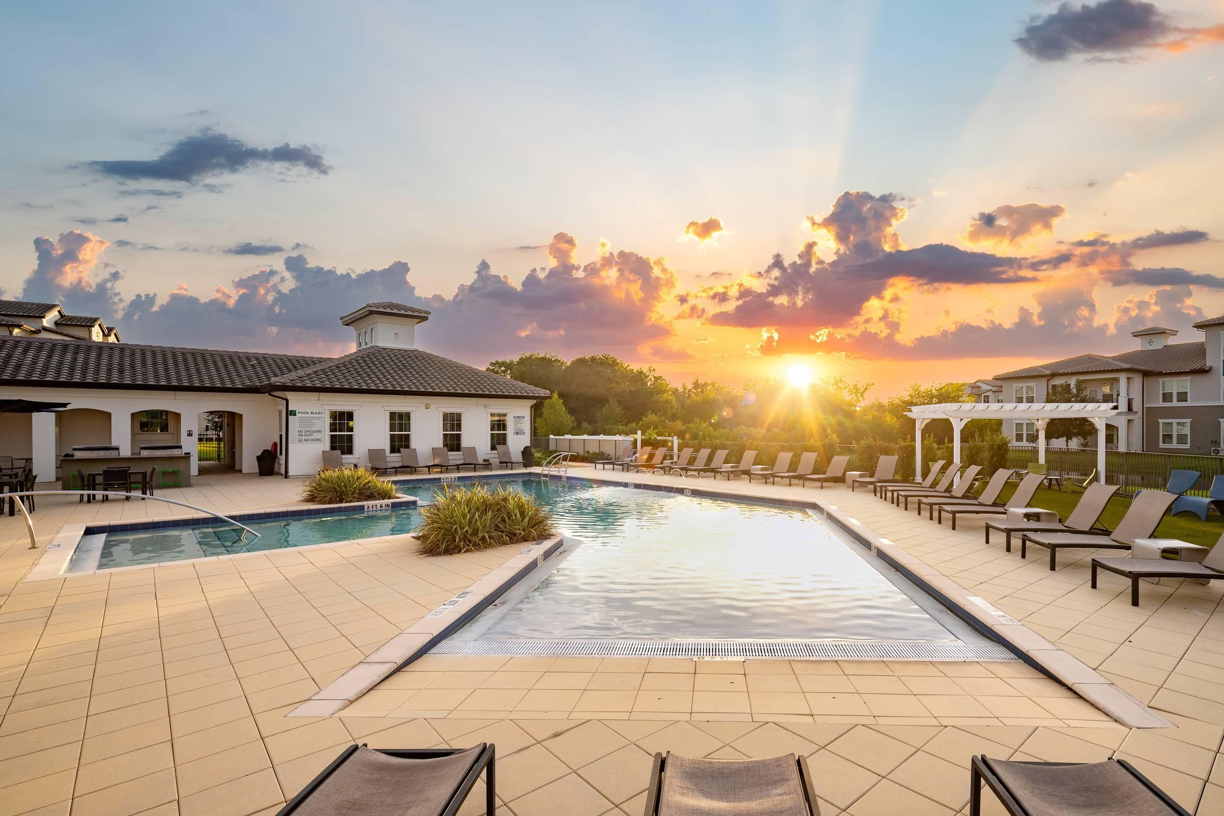 Shadetree Apartments swimming pool and sundeck at sunset