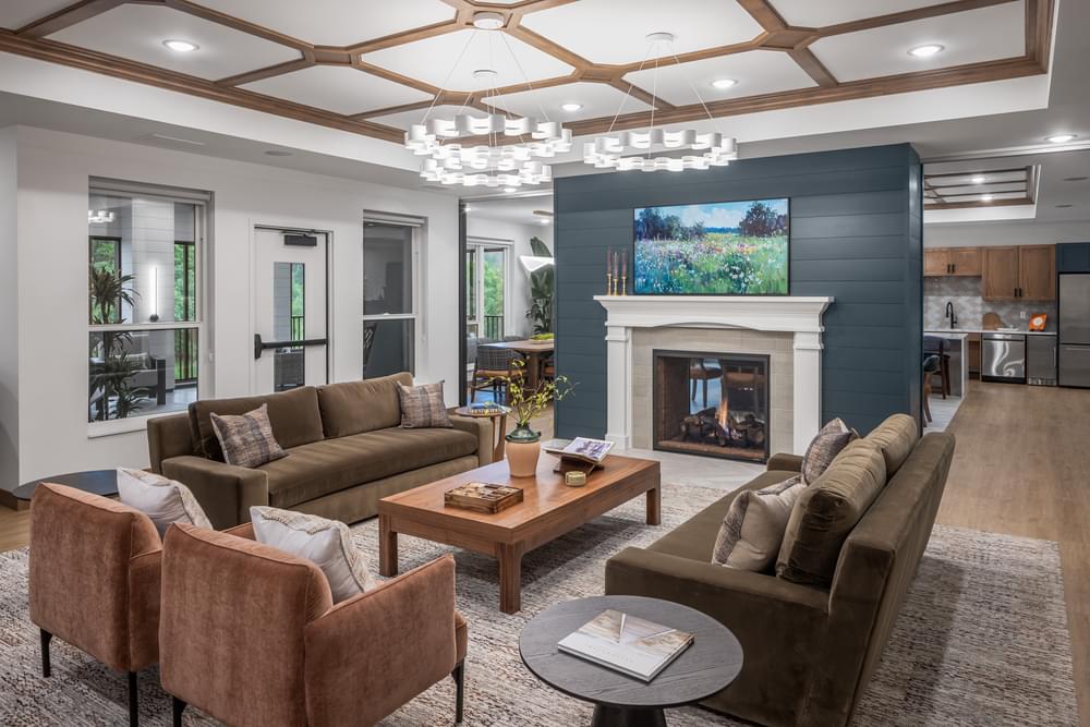 The Ensley with a beautifully-designed club room with a sofa, coffee table, and abundant natural light