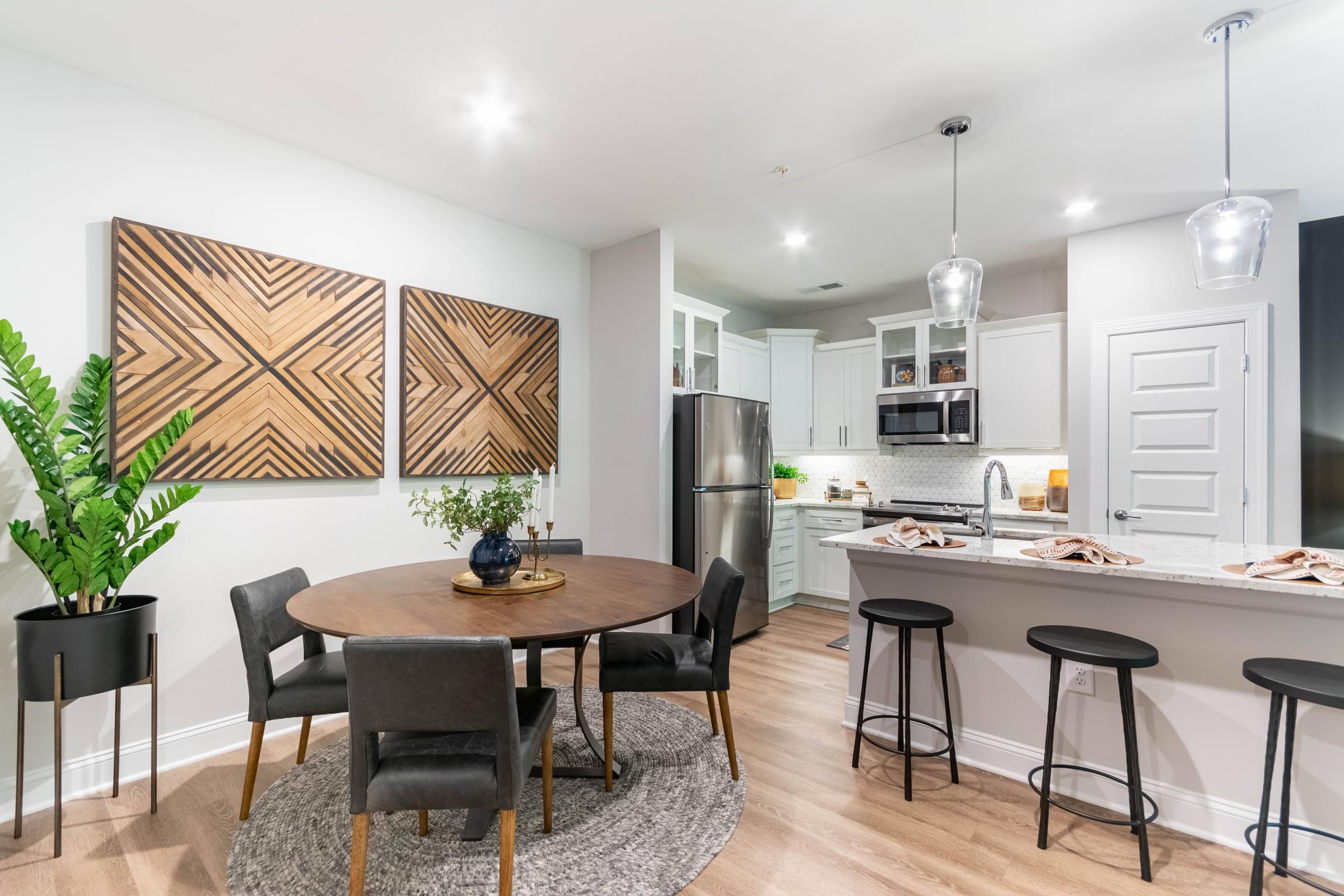 an open kitchen and dining room with a table and chairs