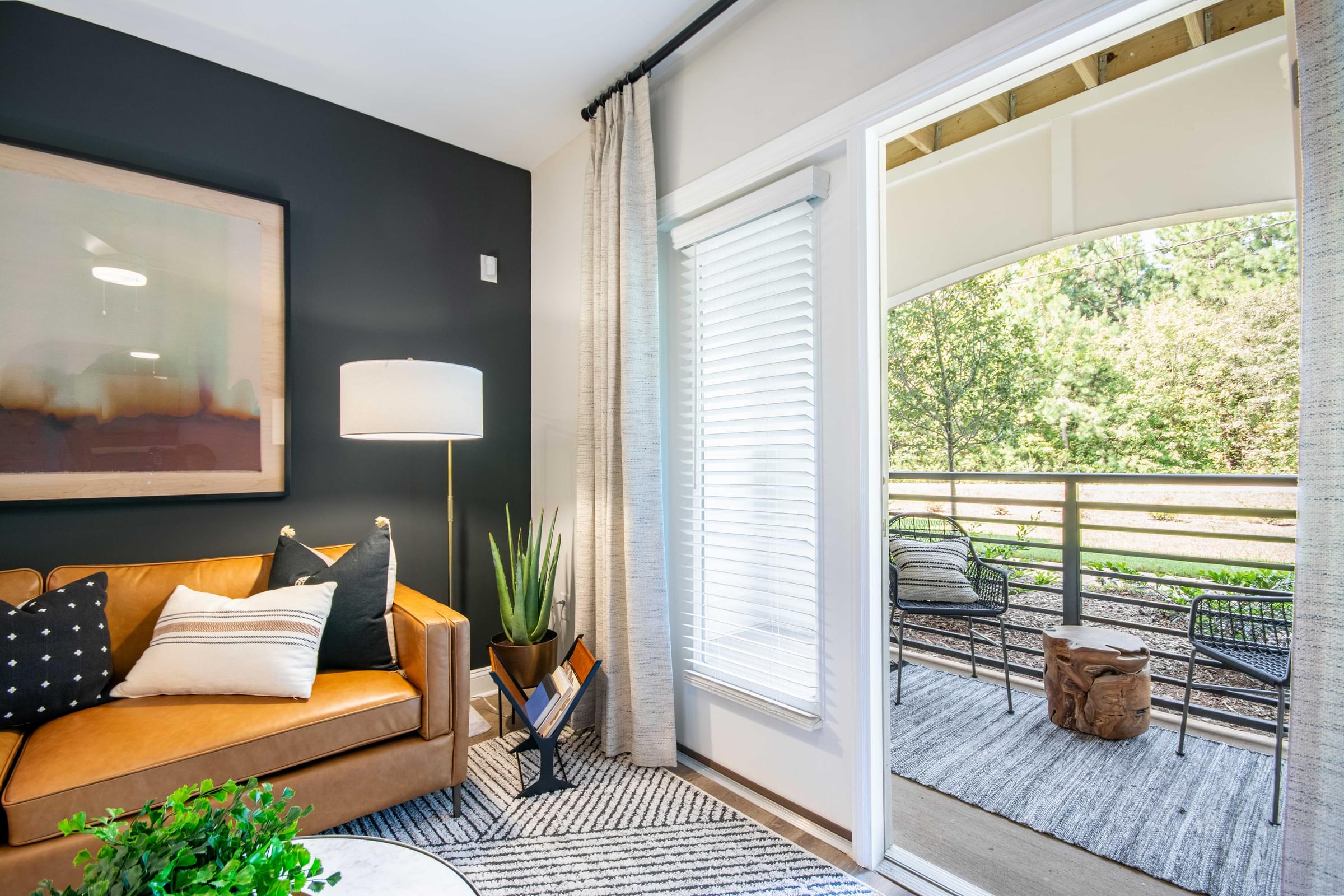 a living room with a couch and a balcony