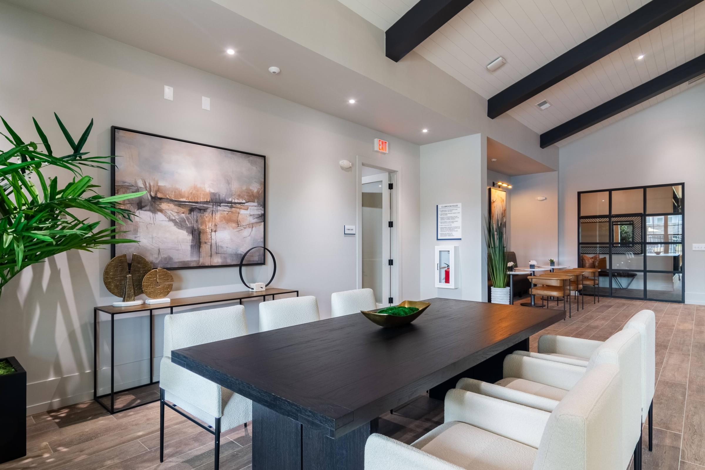 a dining room with white chairs and a wooden table