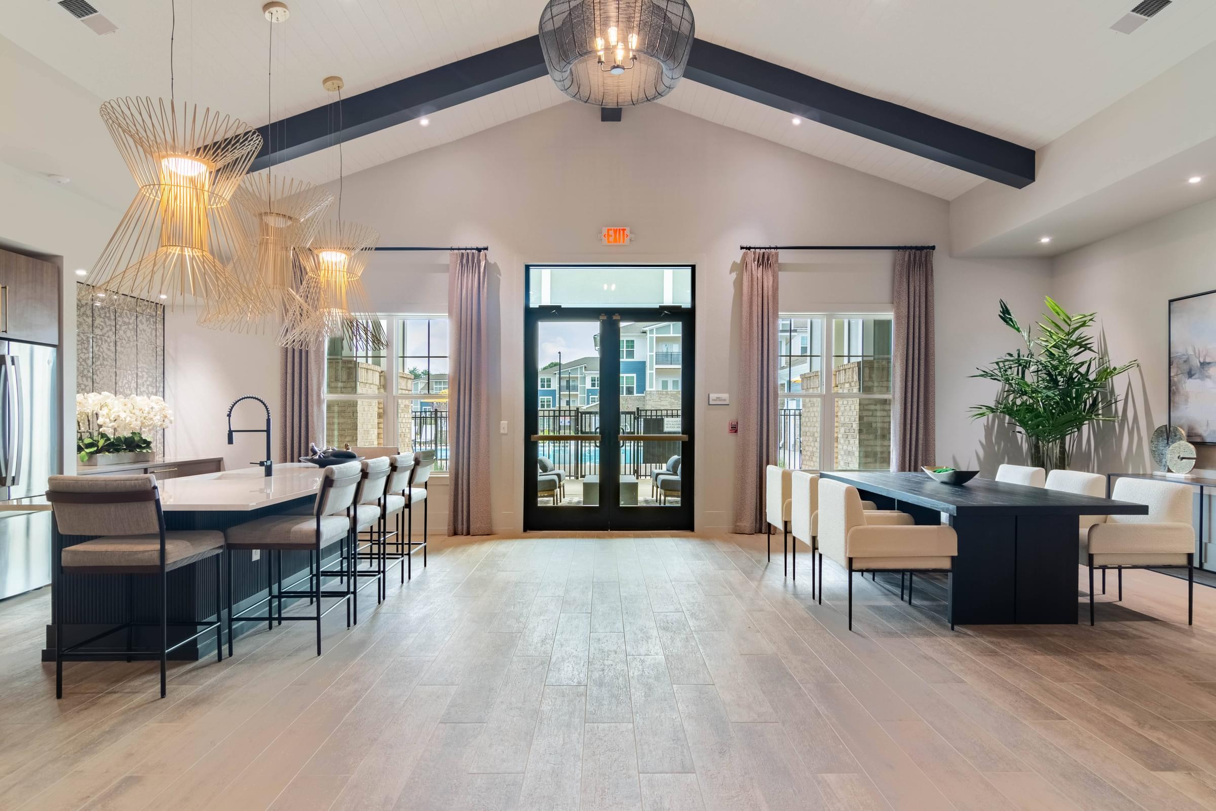 a dining room with a table and chairs and a lobby with doors