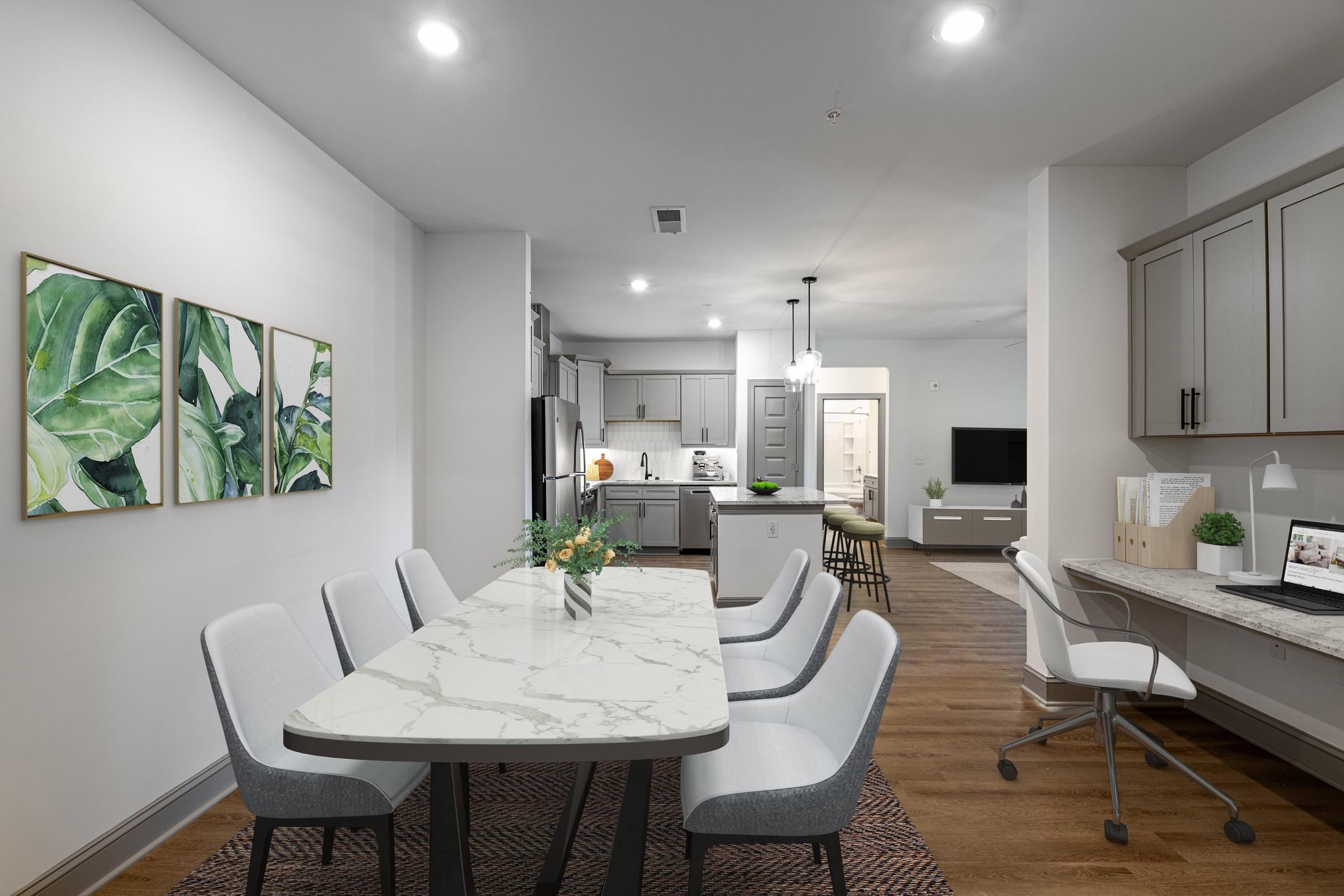 an open kitchen and dining room with white chairs and a marble table