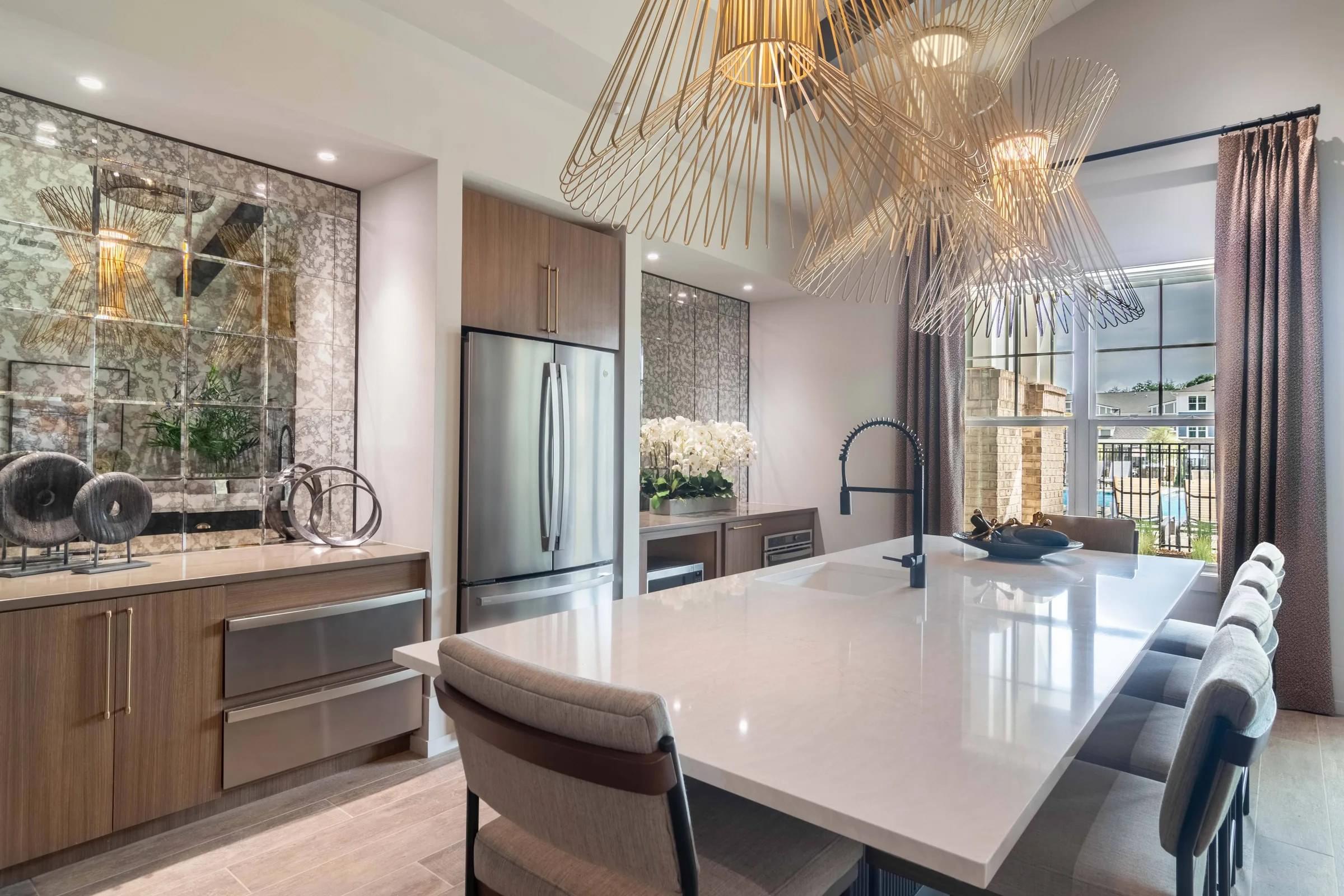 A modern kitchen with a large island and a dining table.
