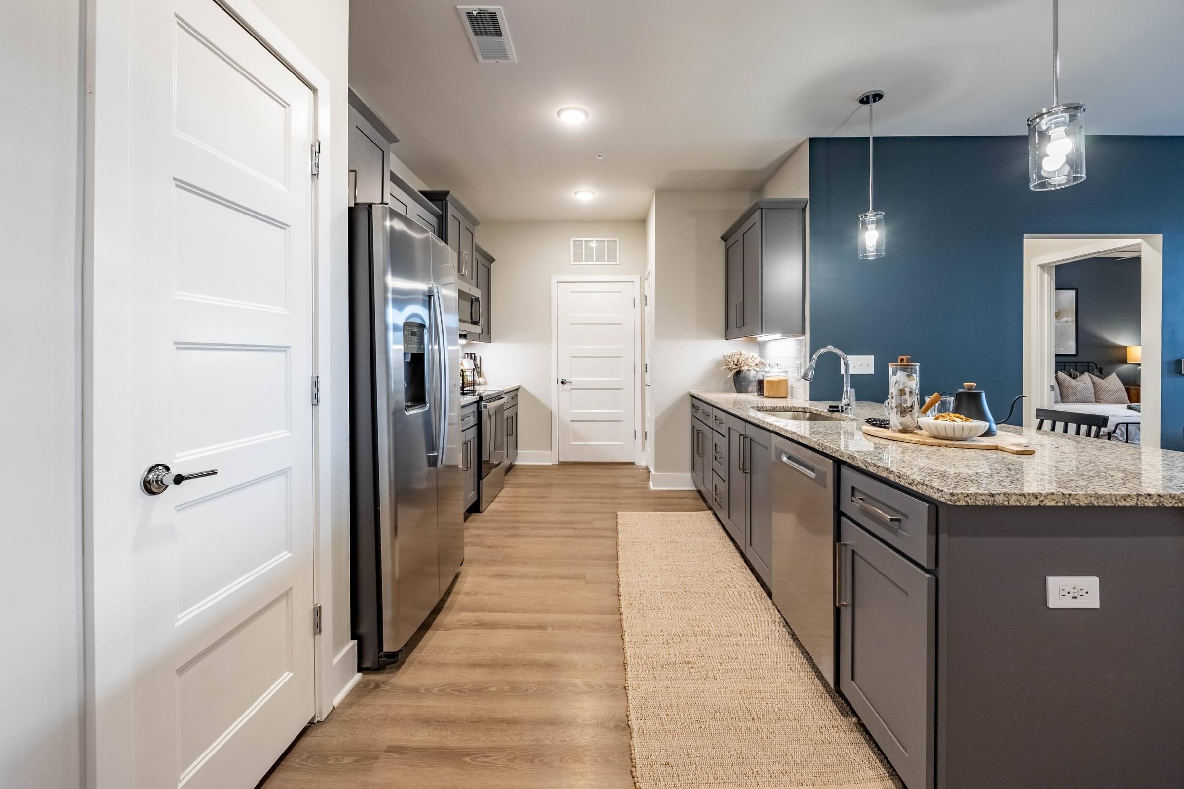 a large kitchen with stainless steel appliances and a counter top