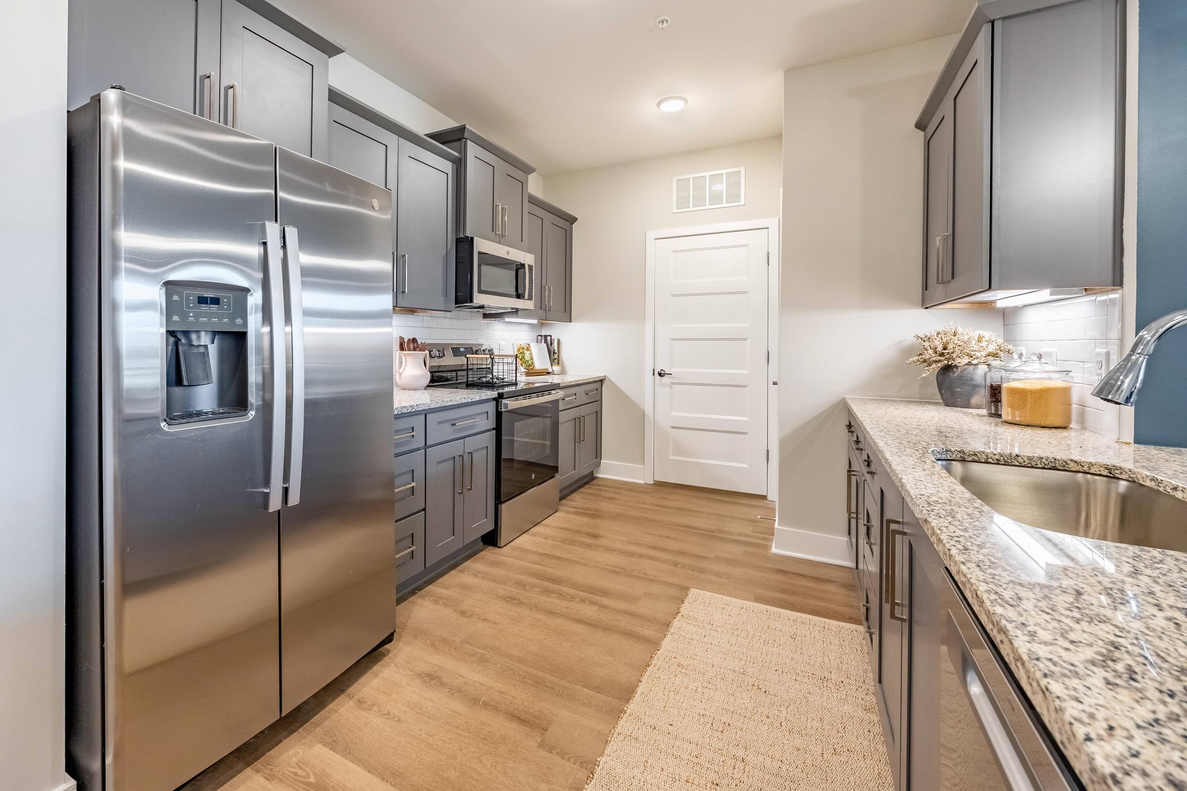 a kitchen with stainless steel appliances and granite counter tops
