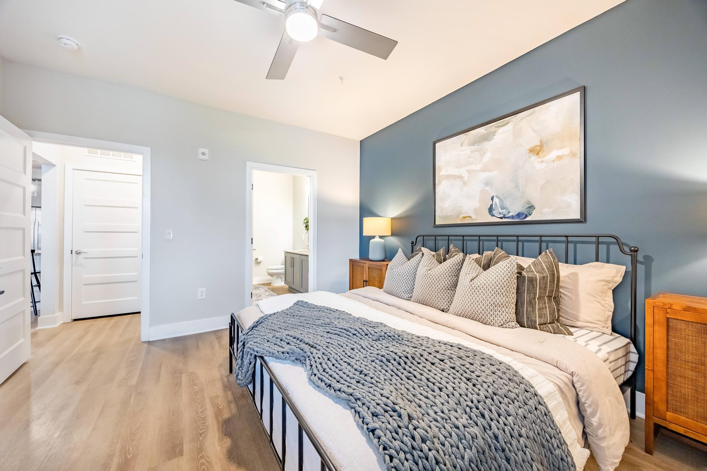 a bedroom with a bed and a ceiling fan