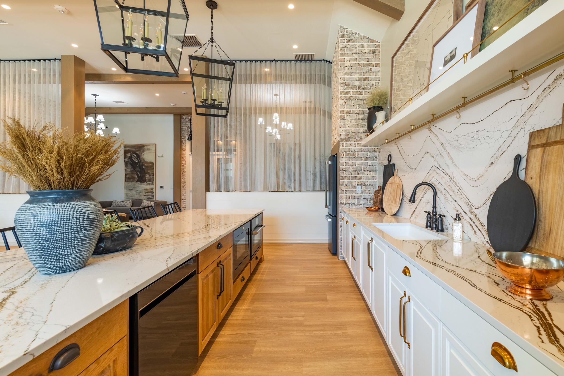 a kitchen with marble counter tops and white cabinets