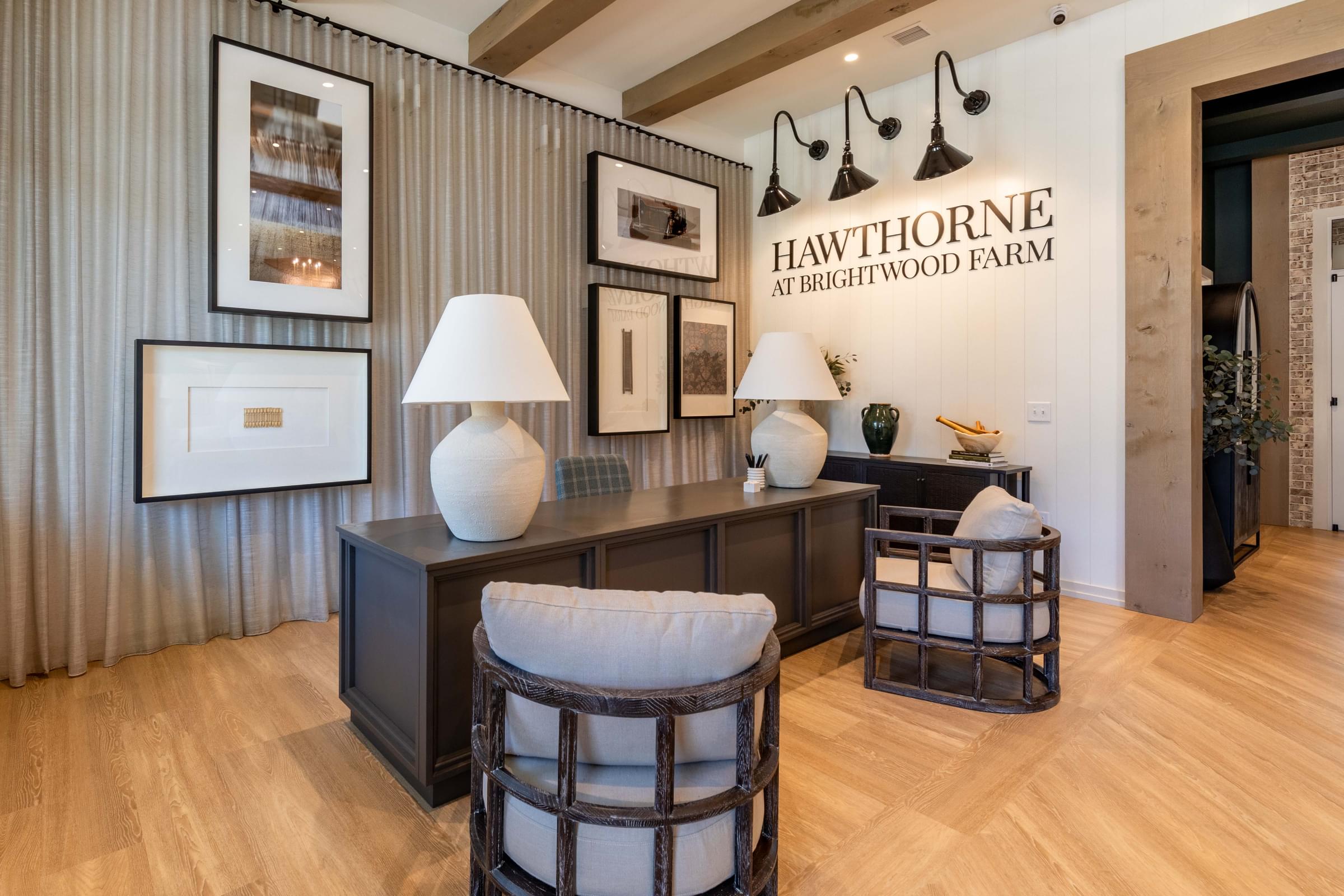 a living room with two stools and a table with lamps