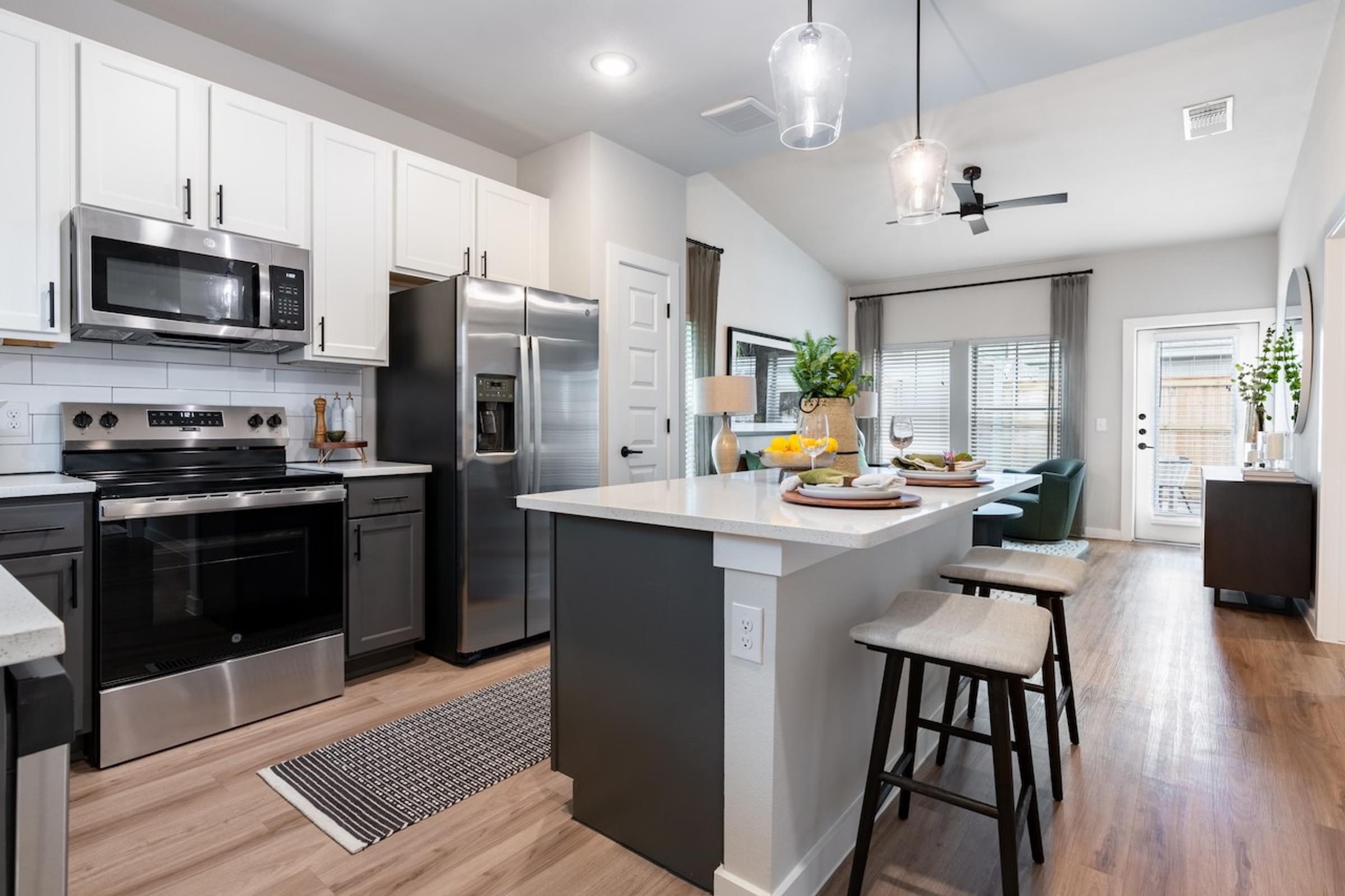 A modern kitchen with stainless steel appliances and a central island.