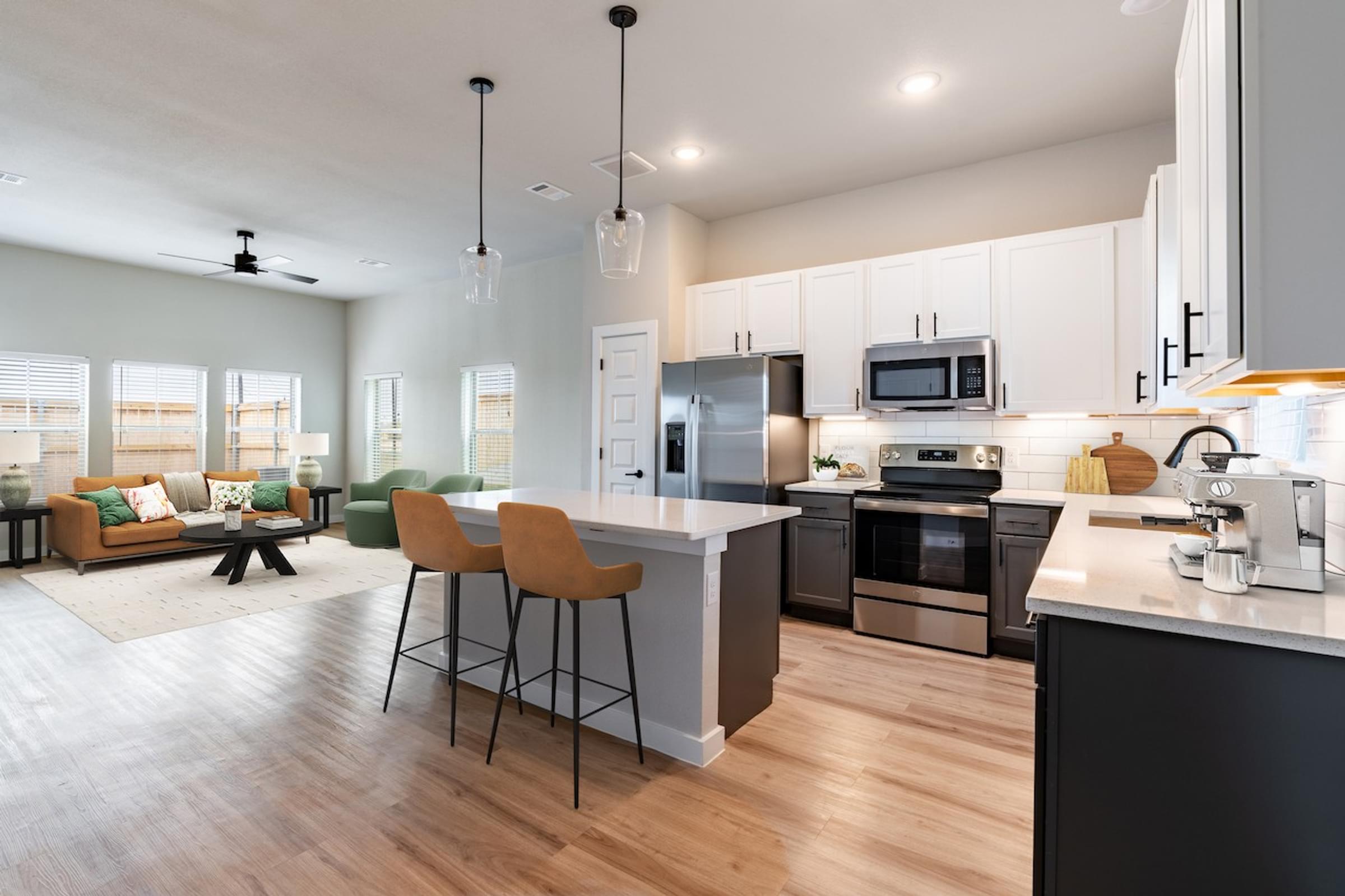 A modern kitchen with a bar area and a dining area.