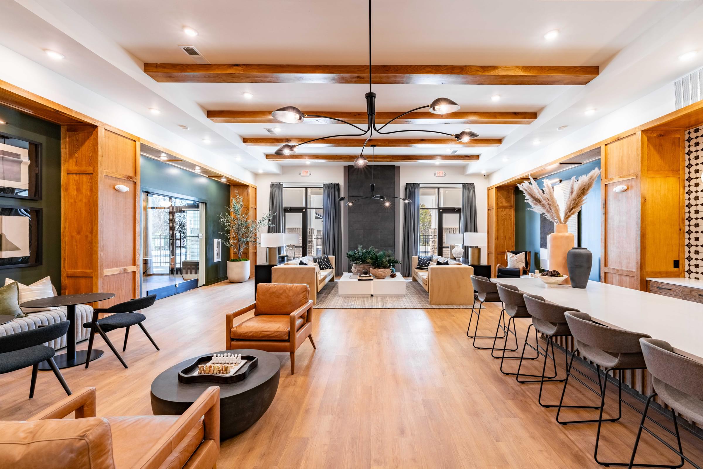 A modern living room with a long wooden table and chairs.