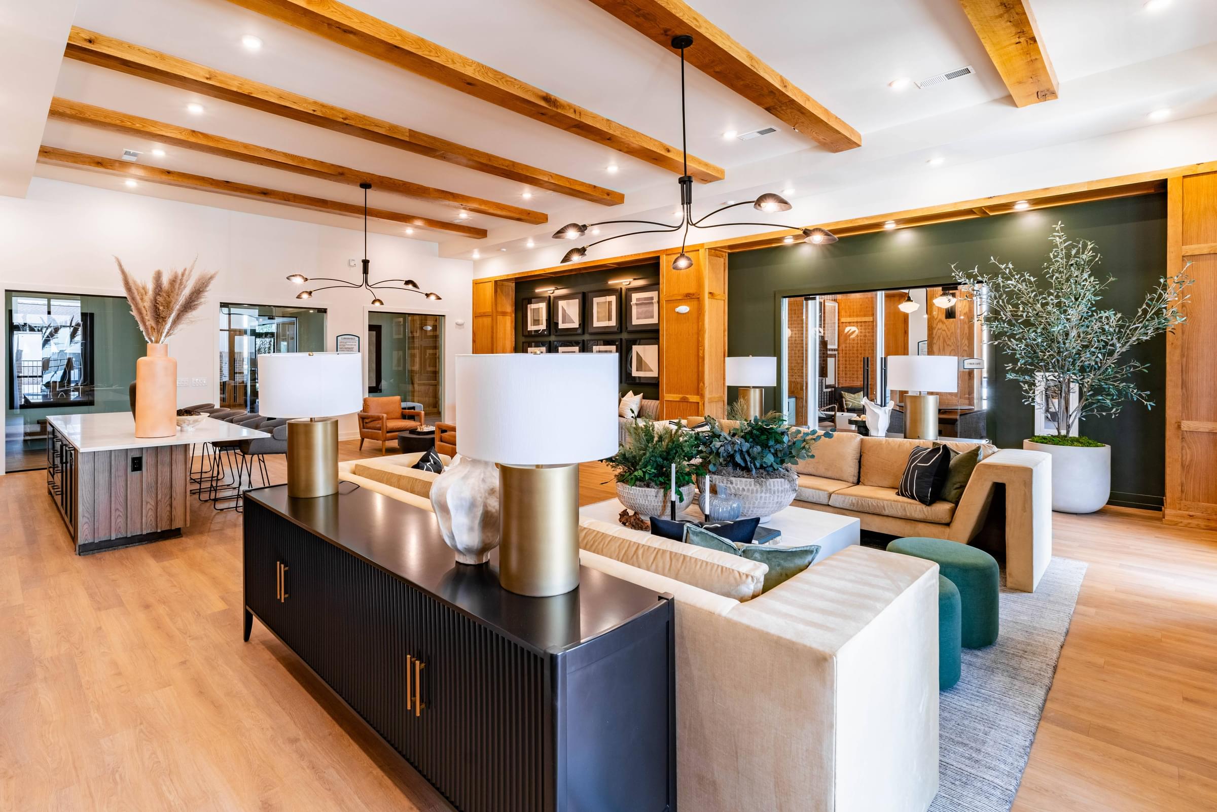 A modern living room with a black and gold console table.