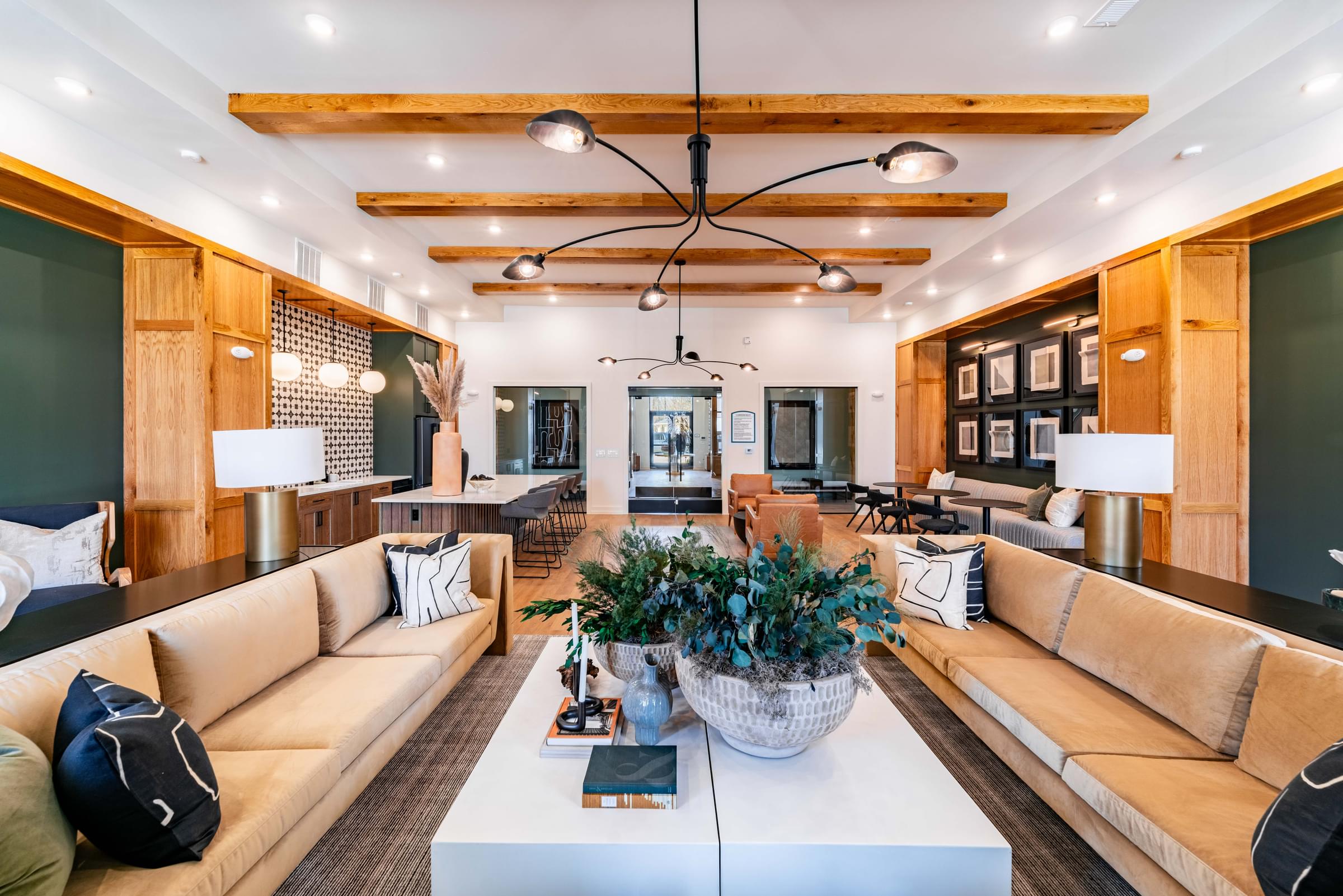 A modern living room with a large white coffee table in the center.
