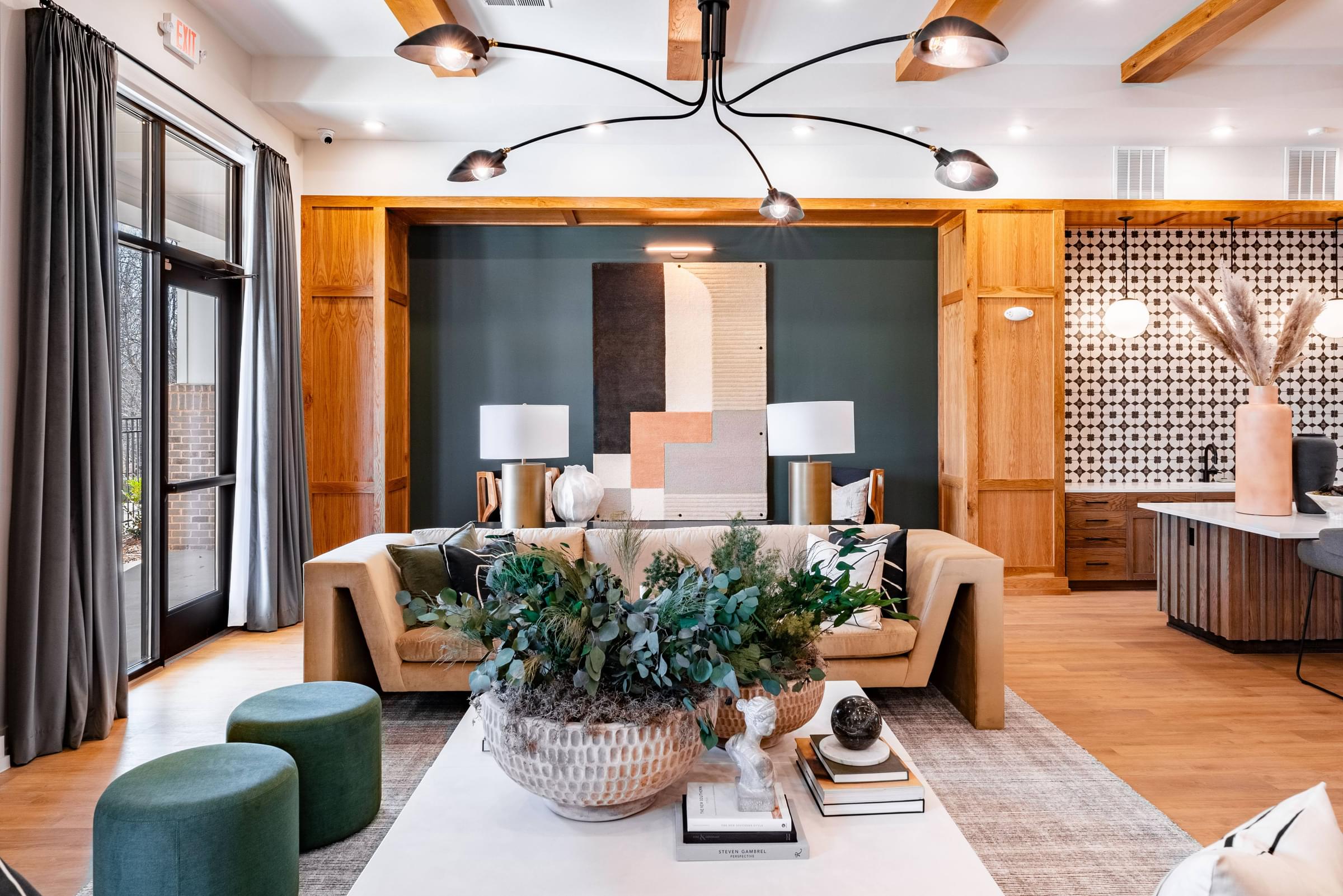 A living room with a large sofa, a coffee table, and a potted plant.