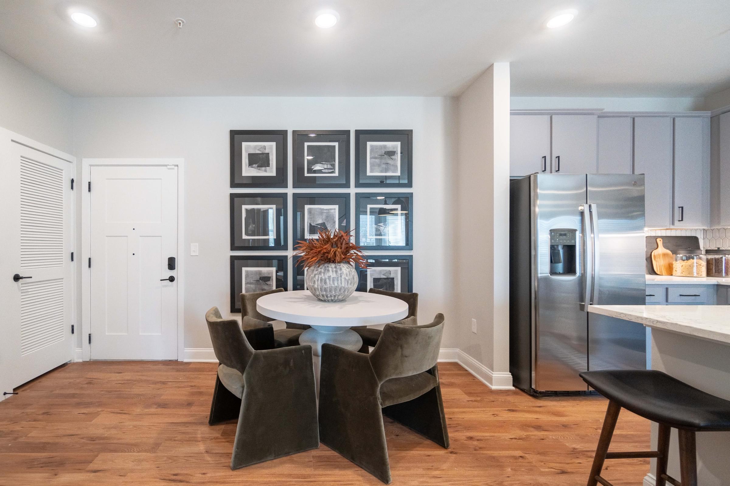 A kitchen with a table and chairs in the middle of the room.