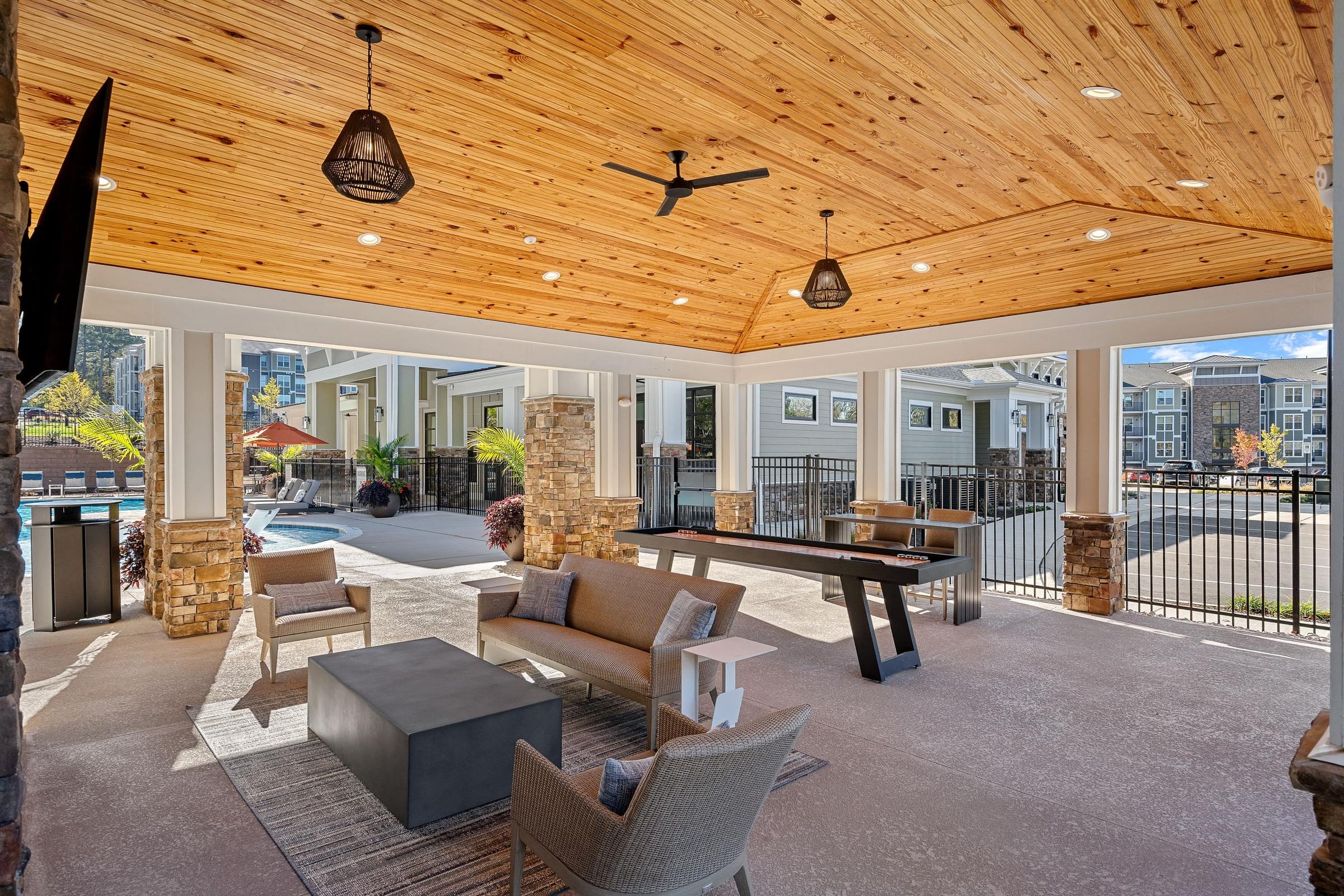A large, open-air covered patio with seating and games.