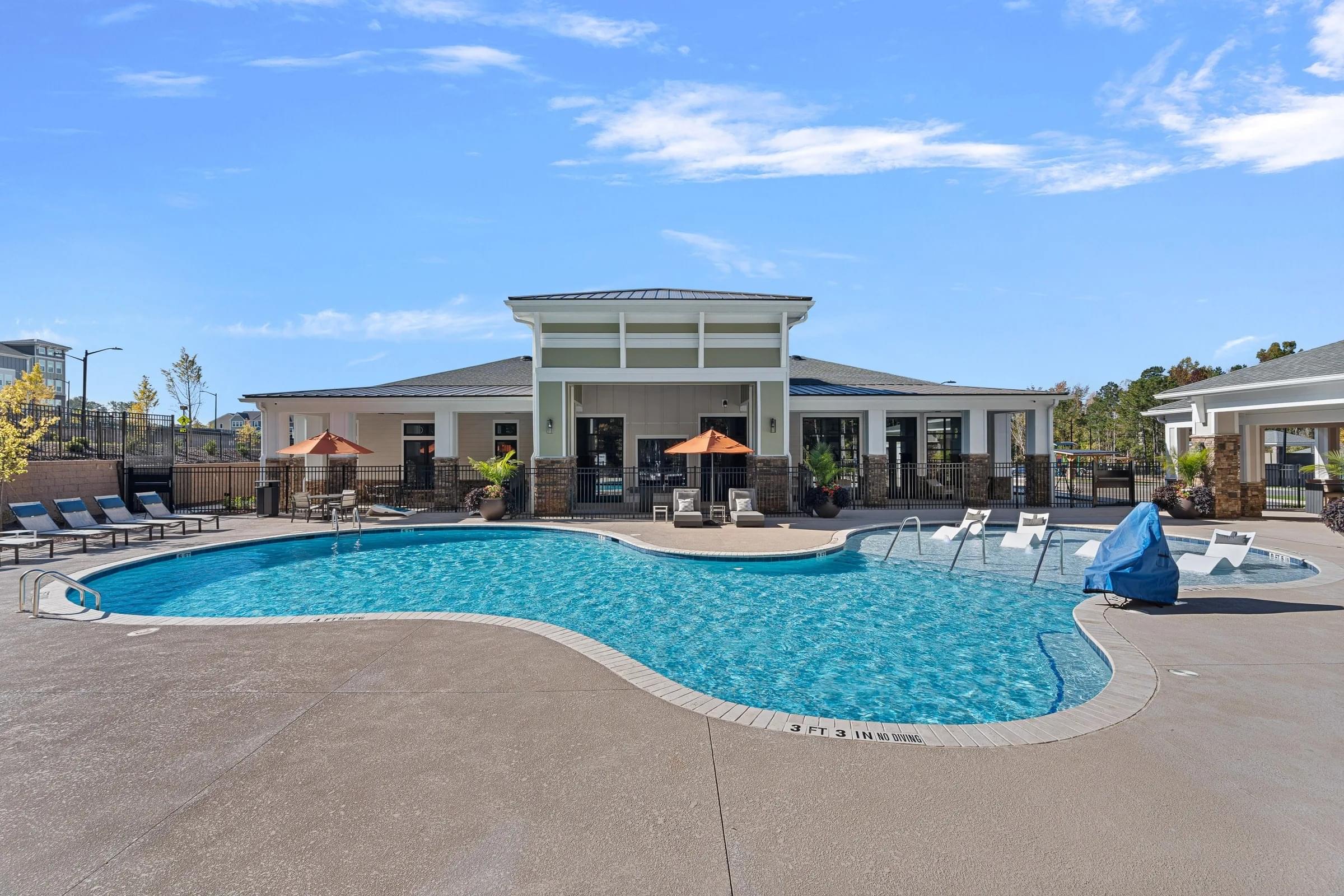A large swimming pool in front of a building.