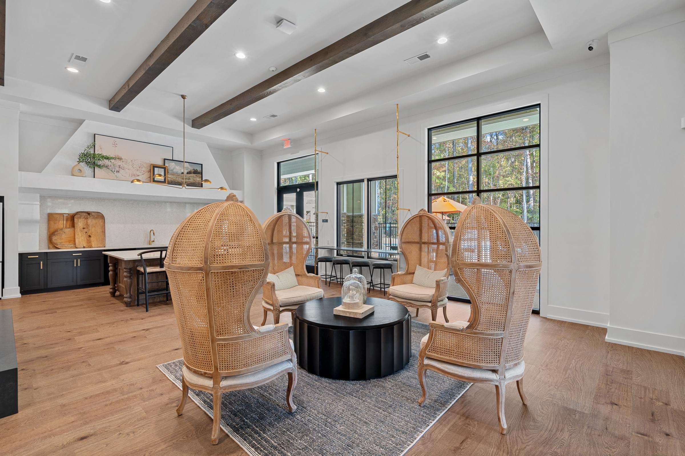 A living room with a round coffee table and four chairs.