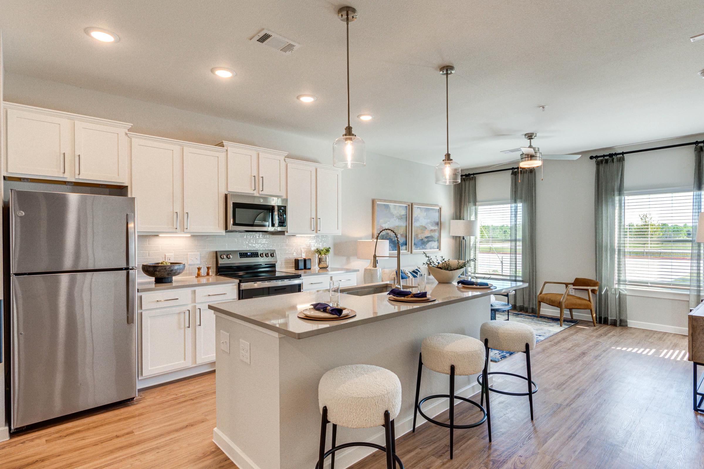 Modern Apartment Kitchen with Stainless Steel Appliances and Quartz Countertops