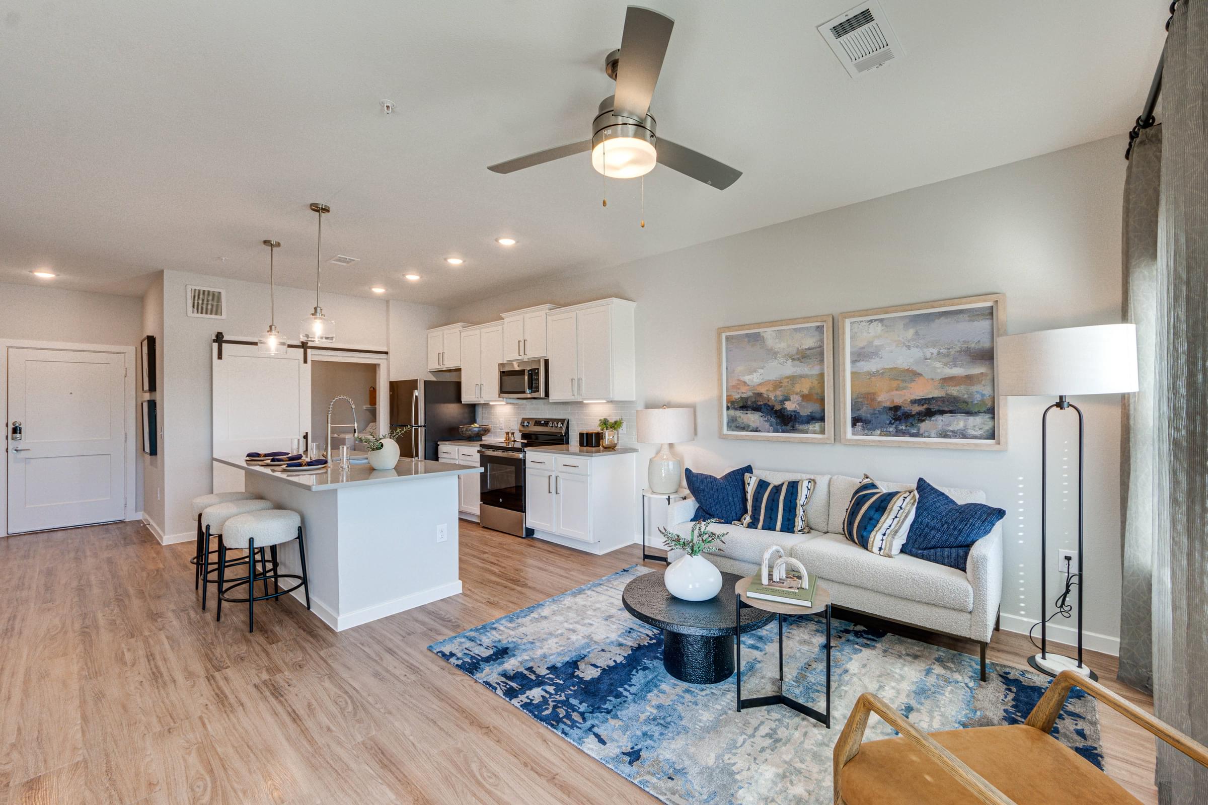 Open-Concept Living Room and Kitchen with White Cabinets and Stainless Steel Appliances