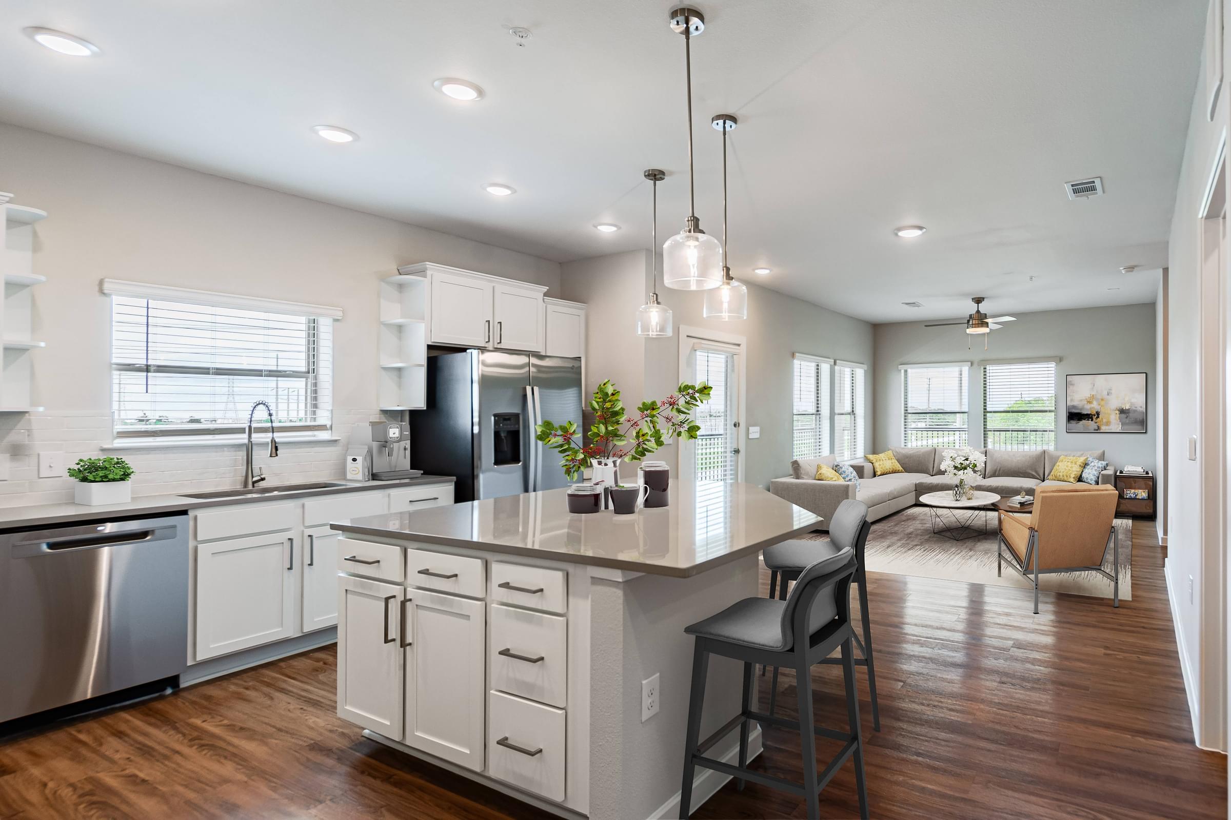 a kitchen with an island and a living room with a couch