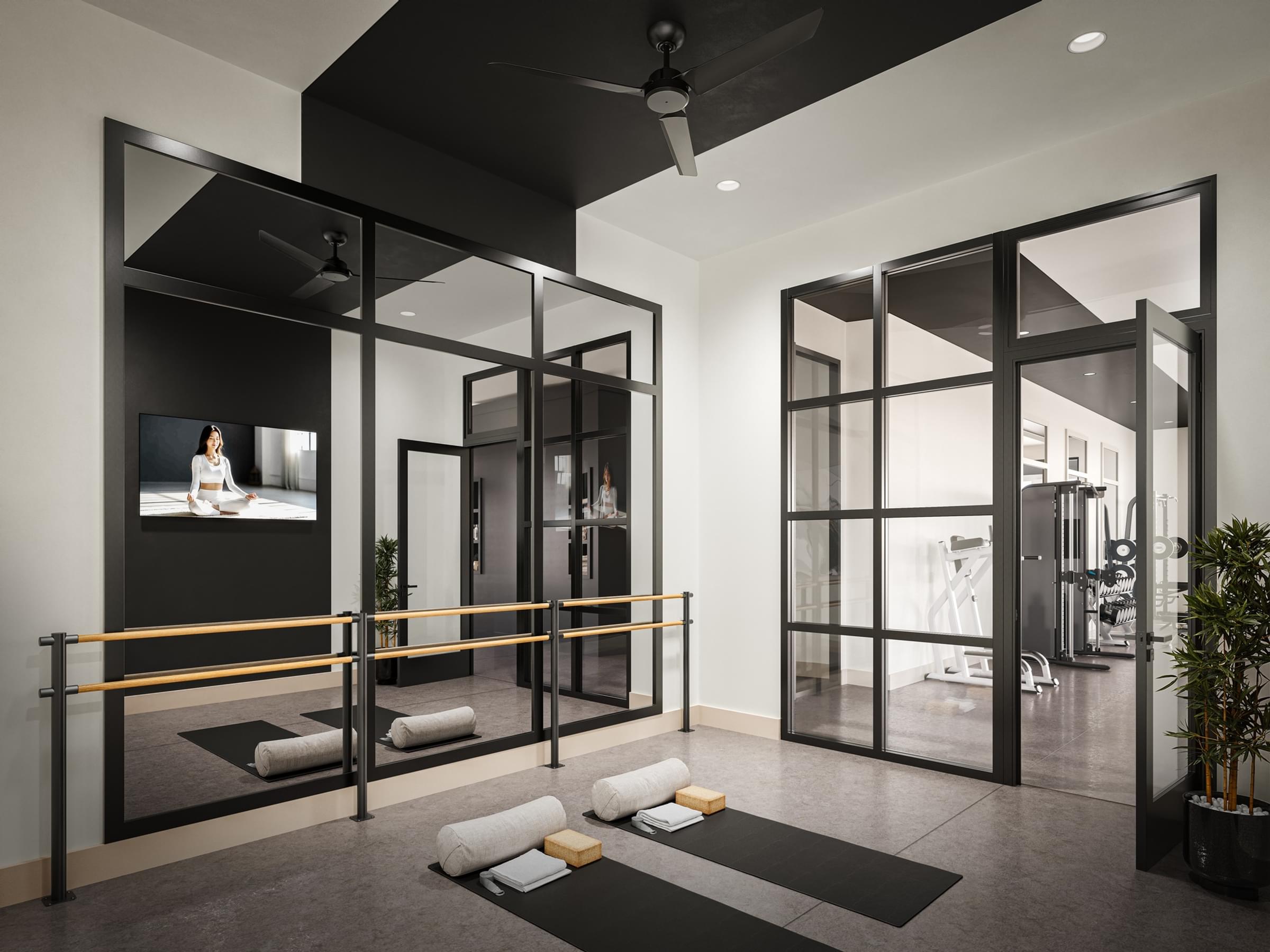 A modern room with a black and white color scheme and a ceiling fan.
