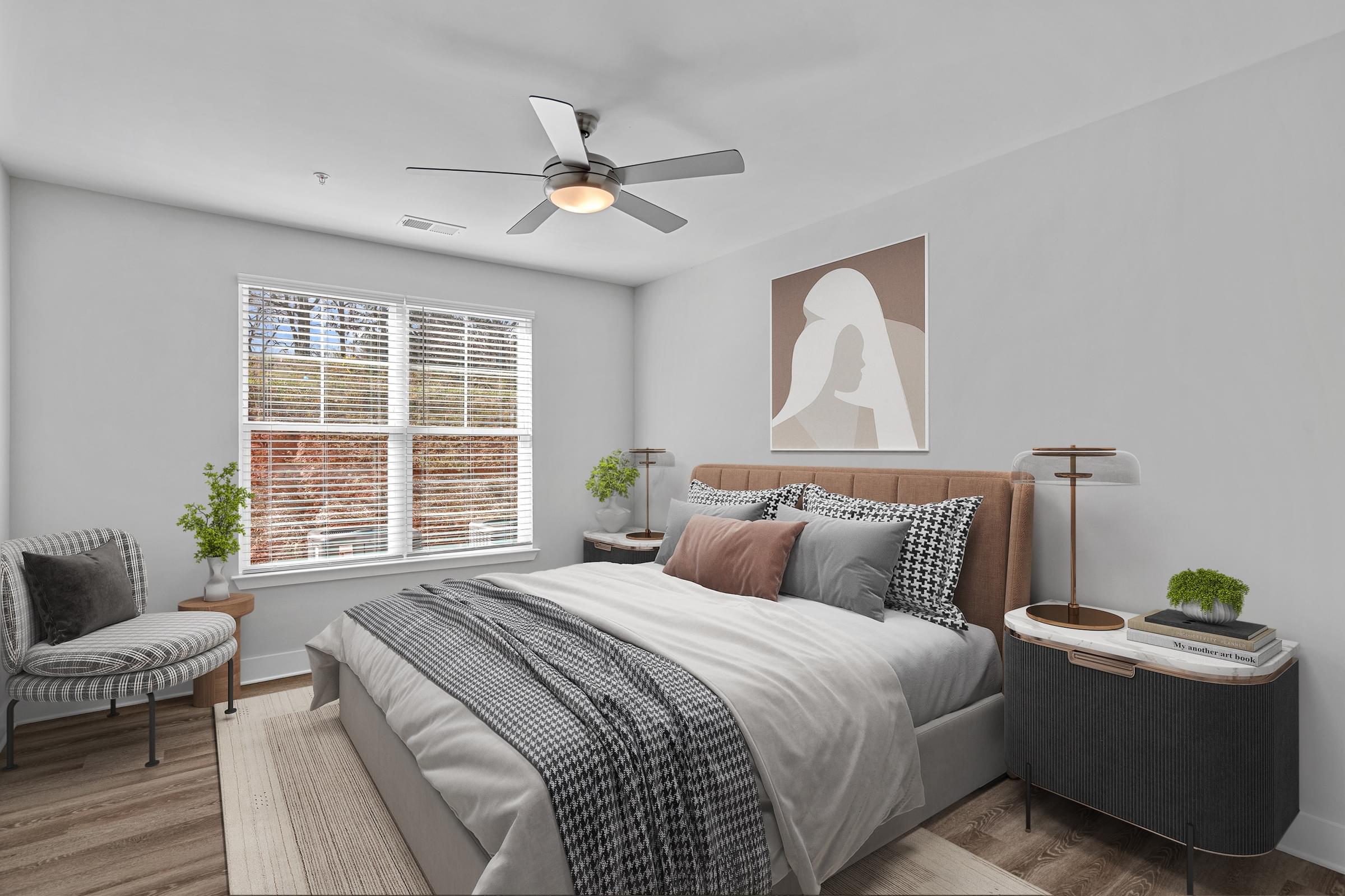A bedroom with a large bed and a ceiling fan.
