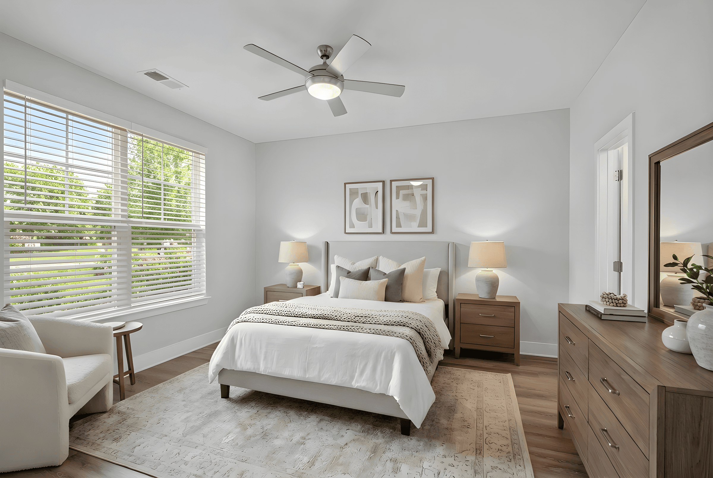 A bedroom with a bed, chair, and a rug.