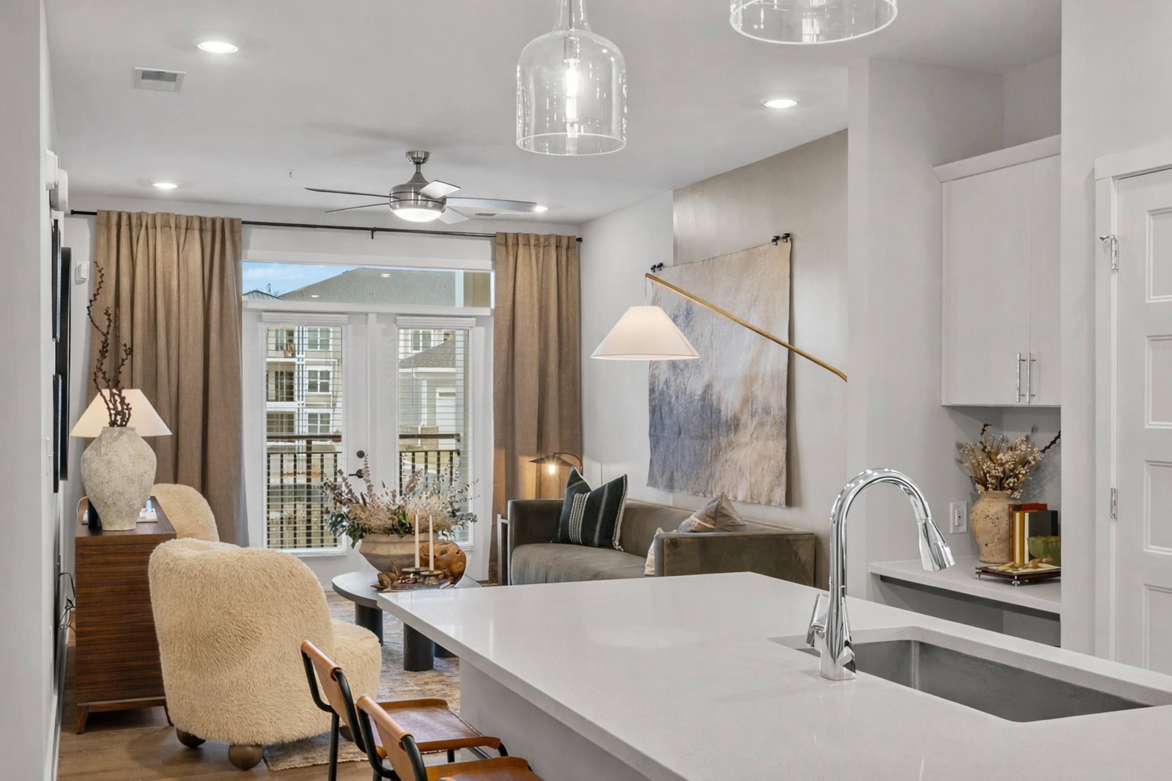 A modern kitchen with a large island and a dining area.