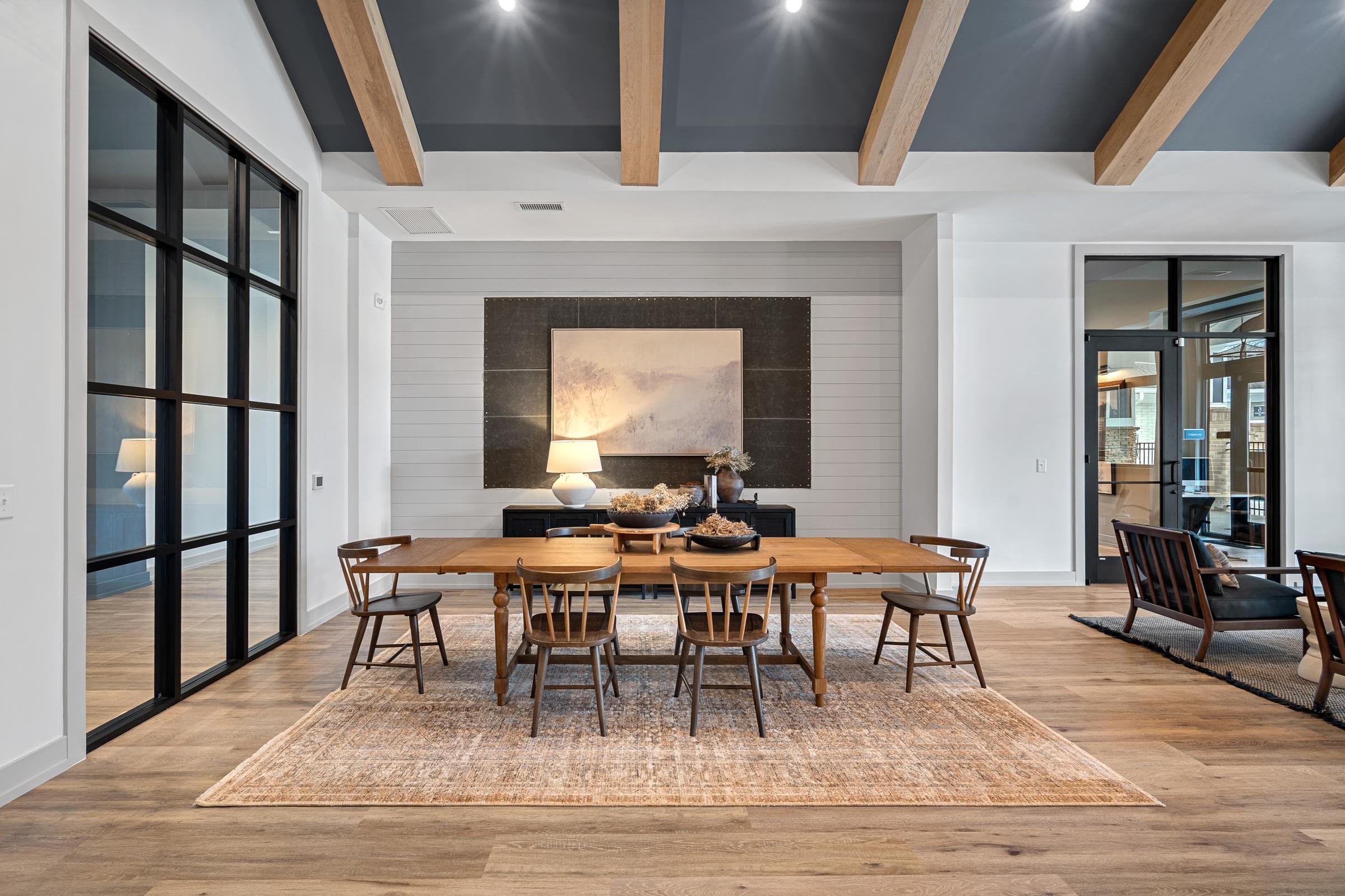 A modern dining room with a wooden table and chairs.