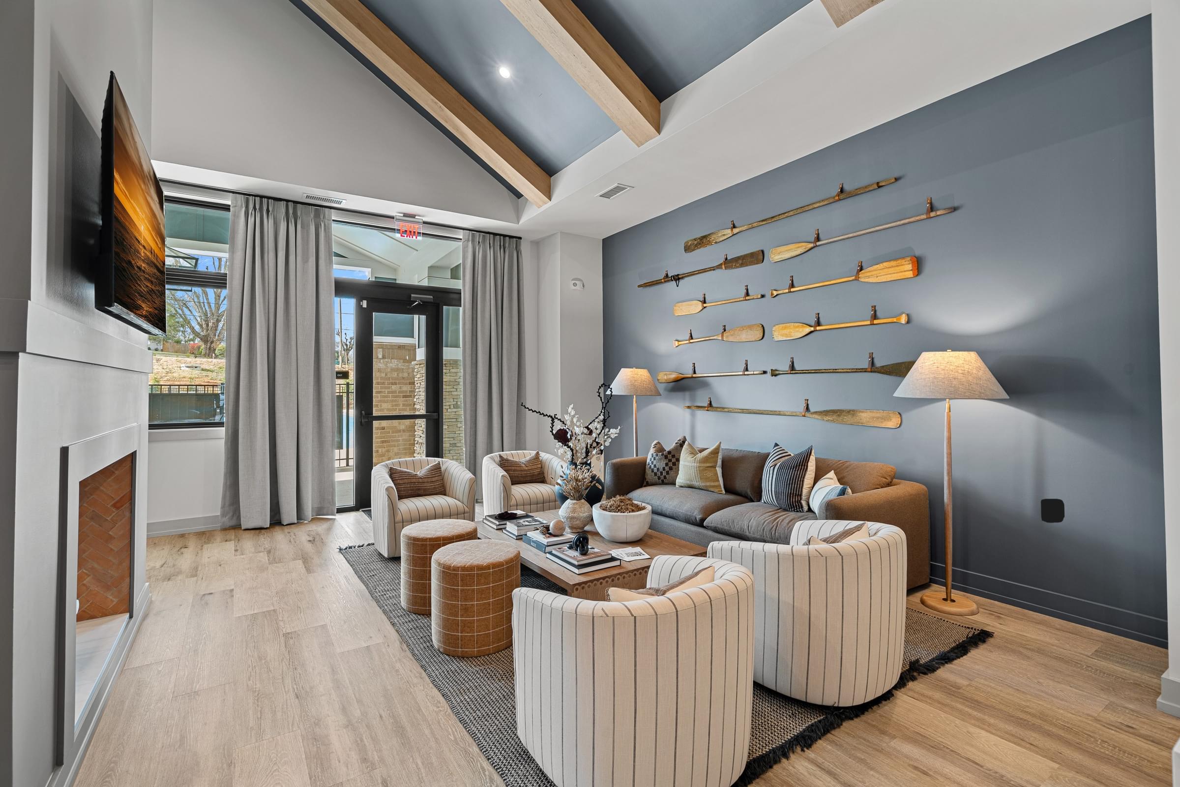 A modern living room with a fireplace and a large flat screen TV.