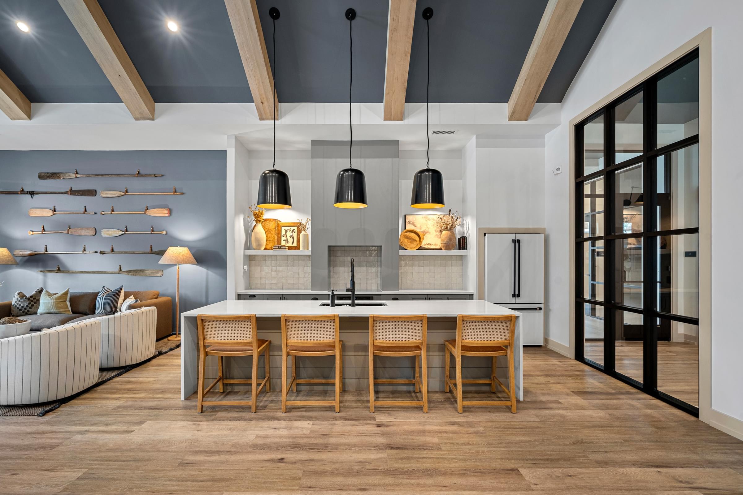 A modern kitchen with a wooden table and chairs.