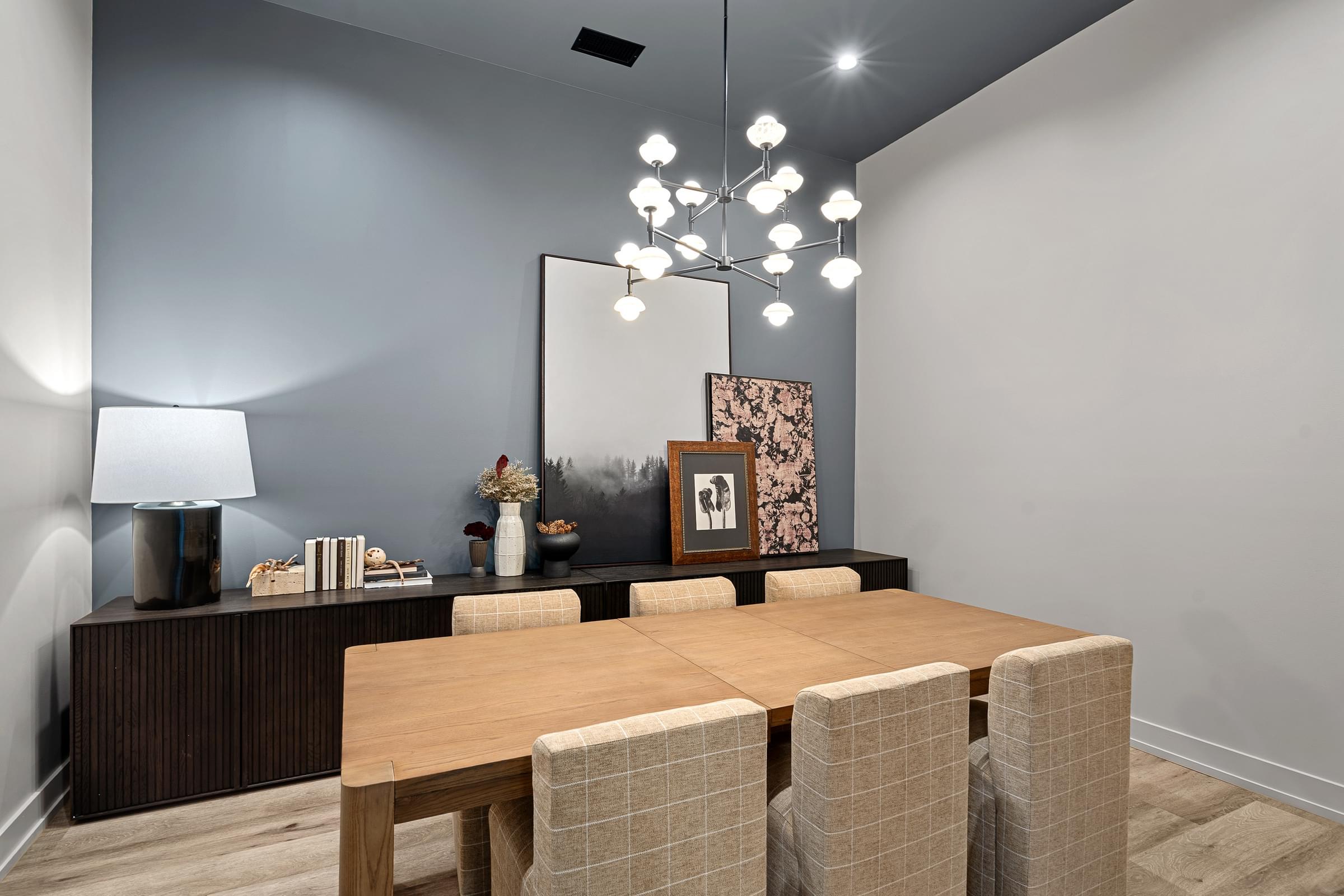 A modern dining room with a wooden table and chairs.
