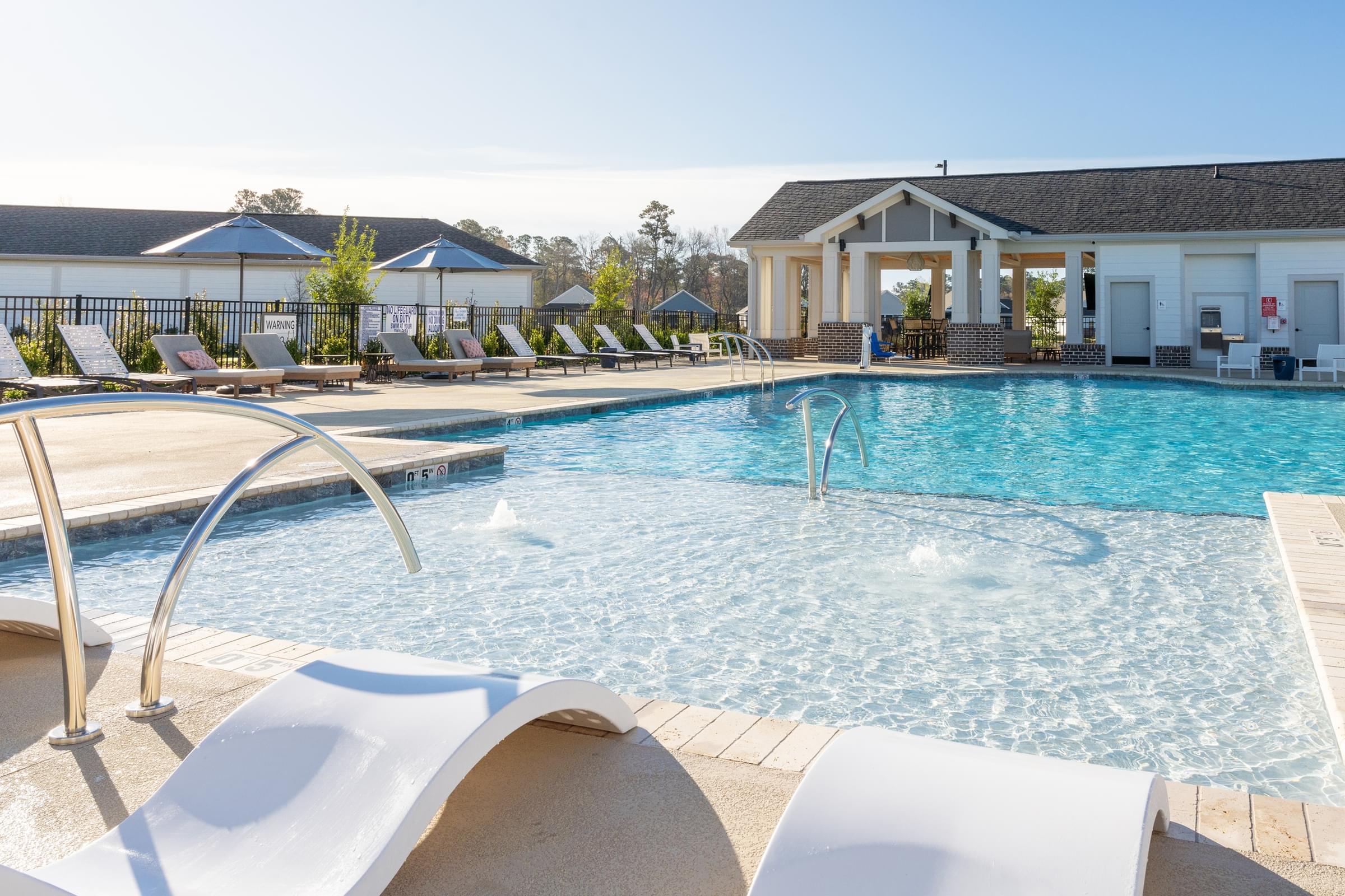 Custom Saltwater Resort-Style Swimming Pool with a Sun Shelf and Inset Seating