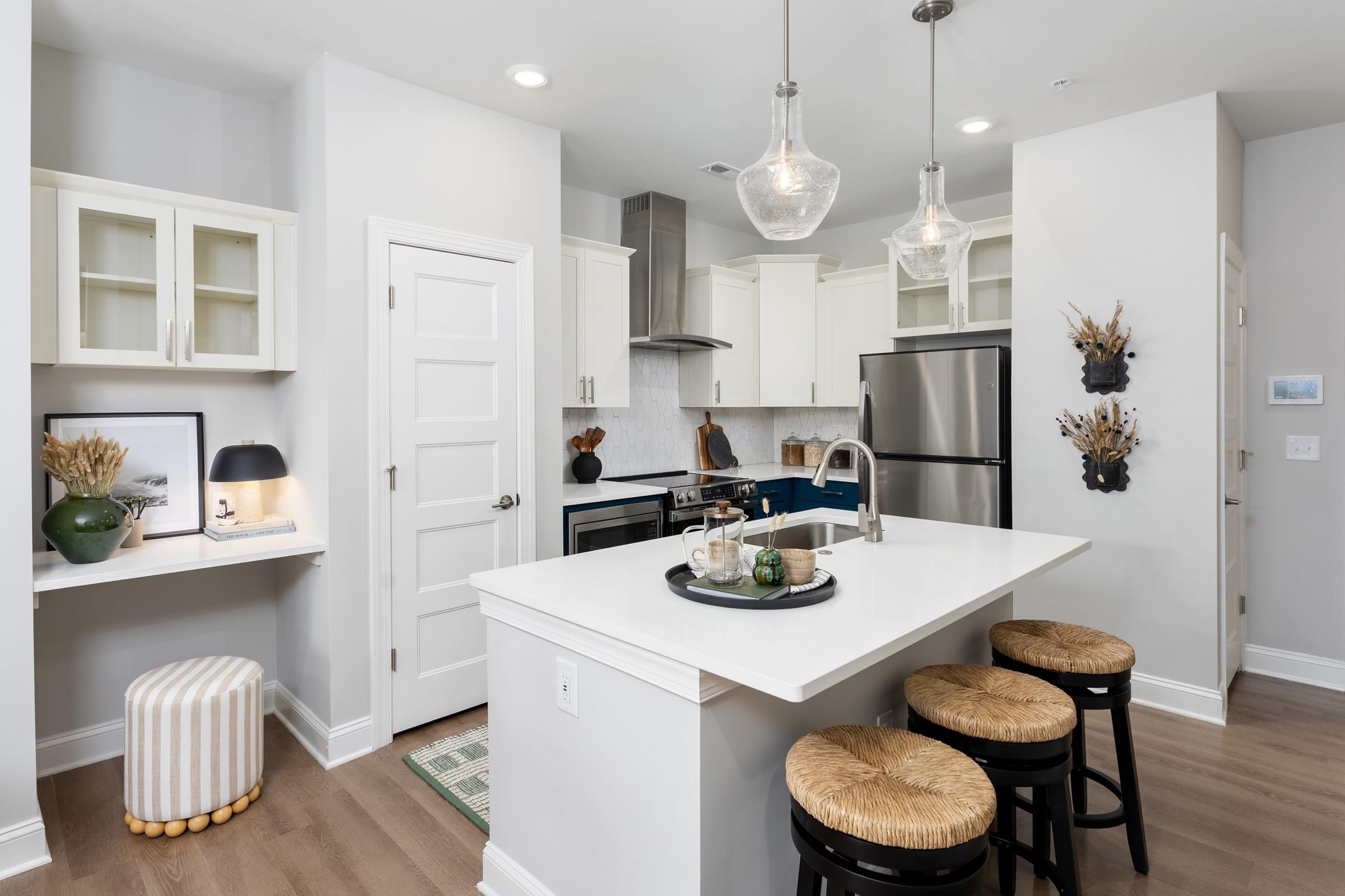 Modern Kitchen with White Cabinets and Stainless Steel Appliances and a Built-in Desk