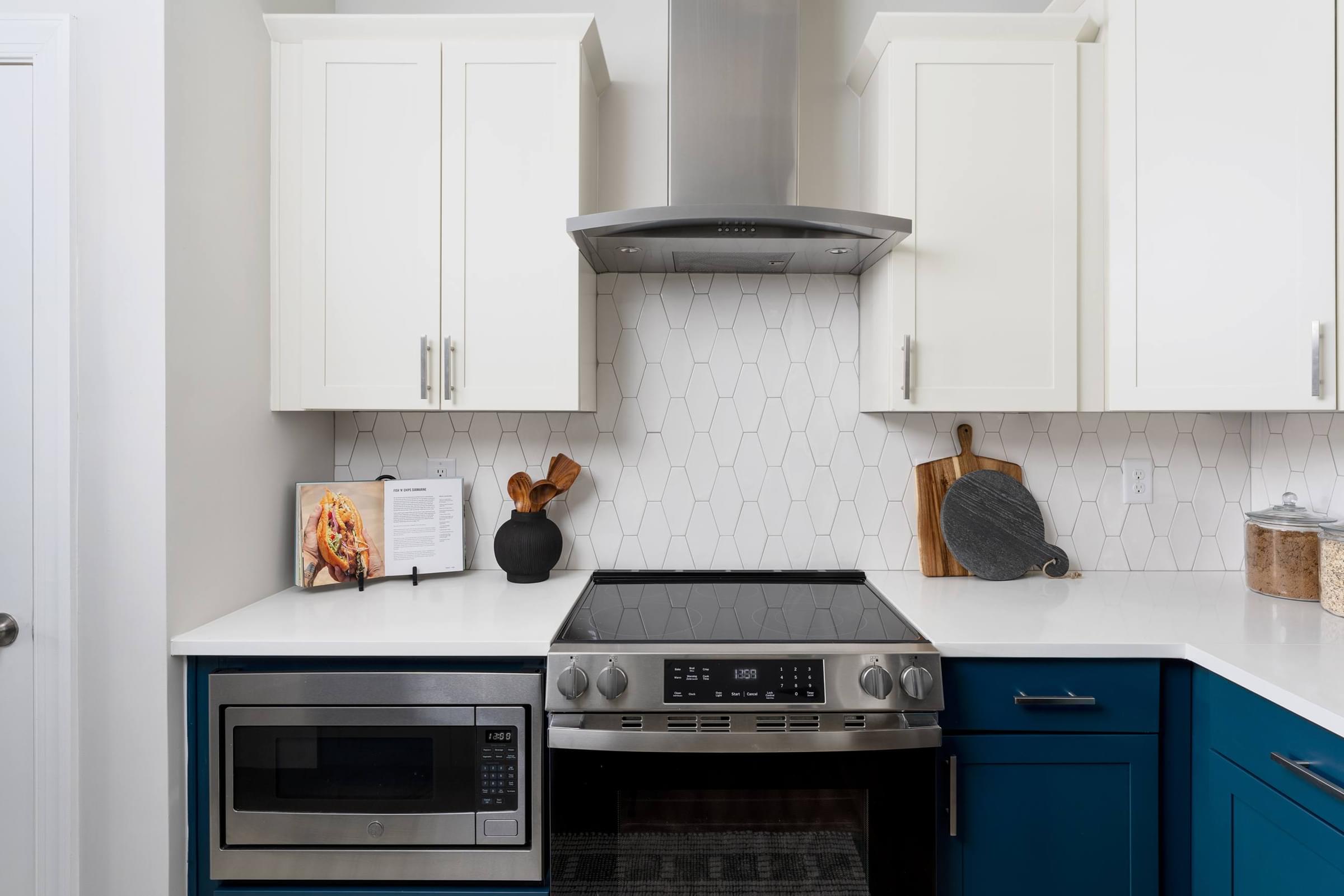 Modern Kitchen with Blue and White Cabinets and Stainless Steel Appliances