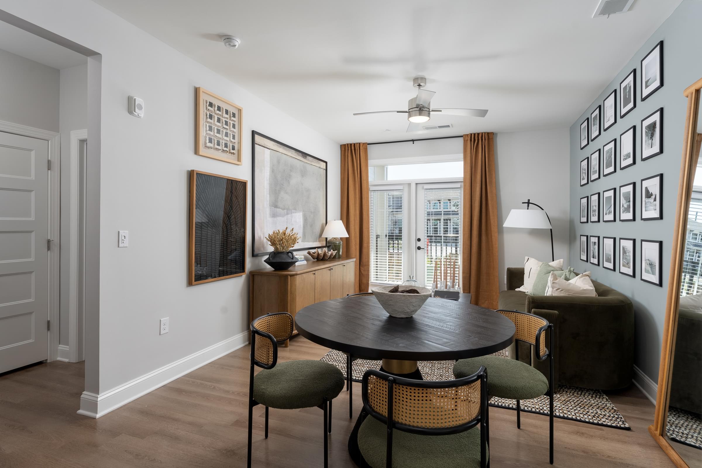 A living room with a table and chairs.