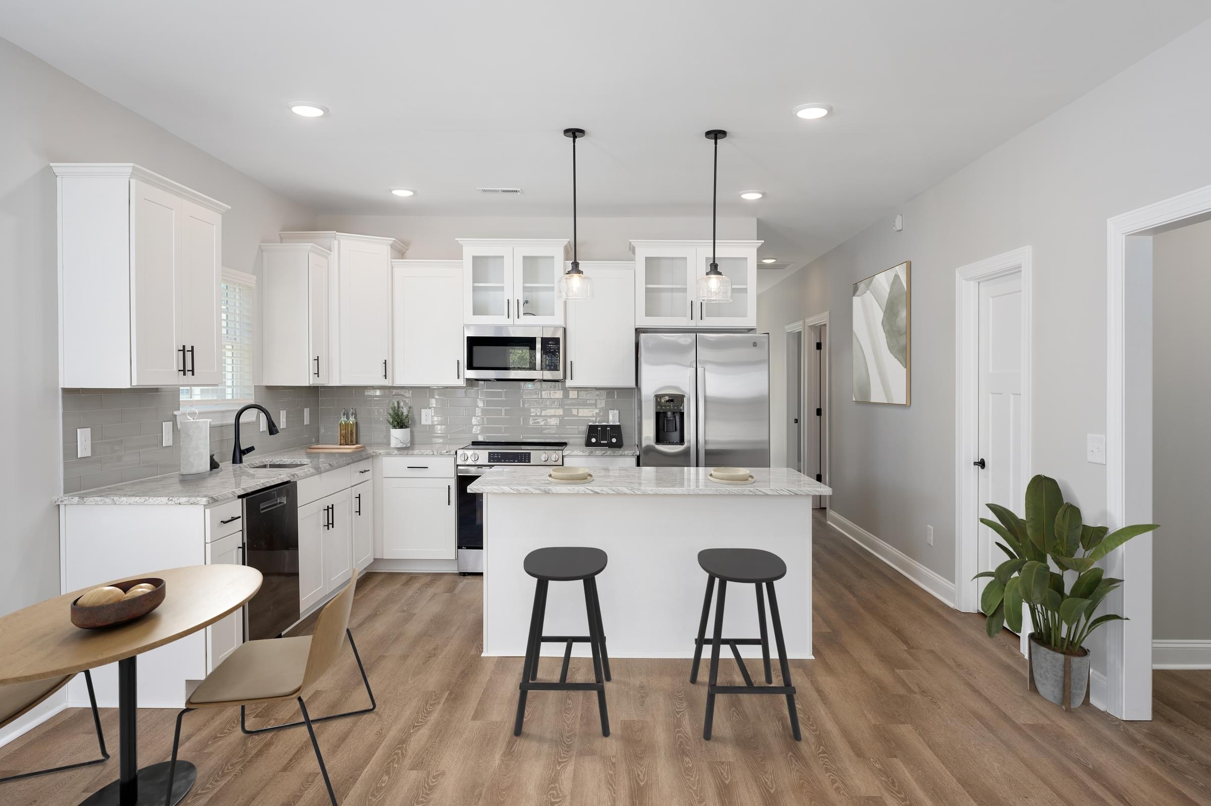 A modern kitchen with white cabinets and a central island.