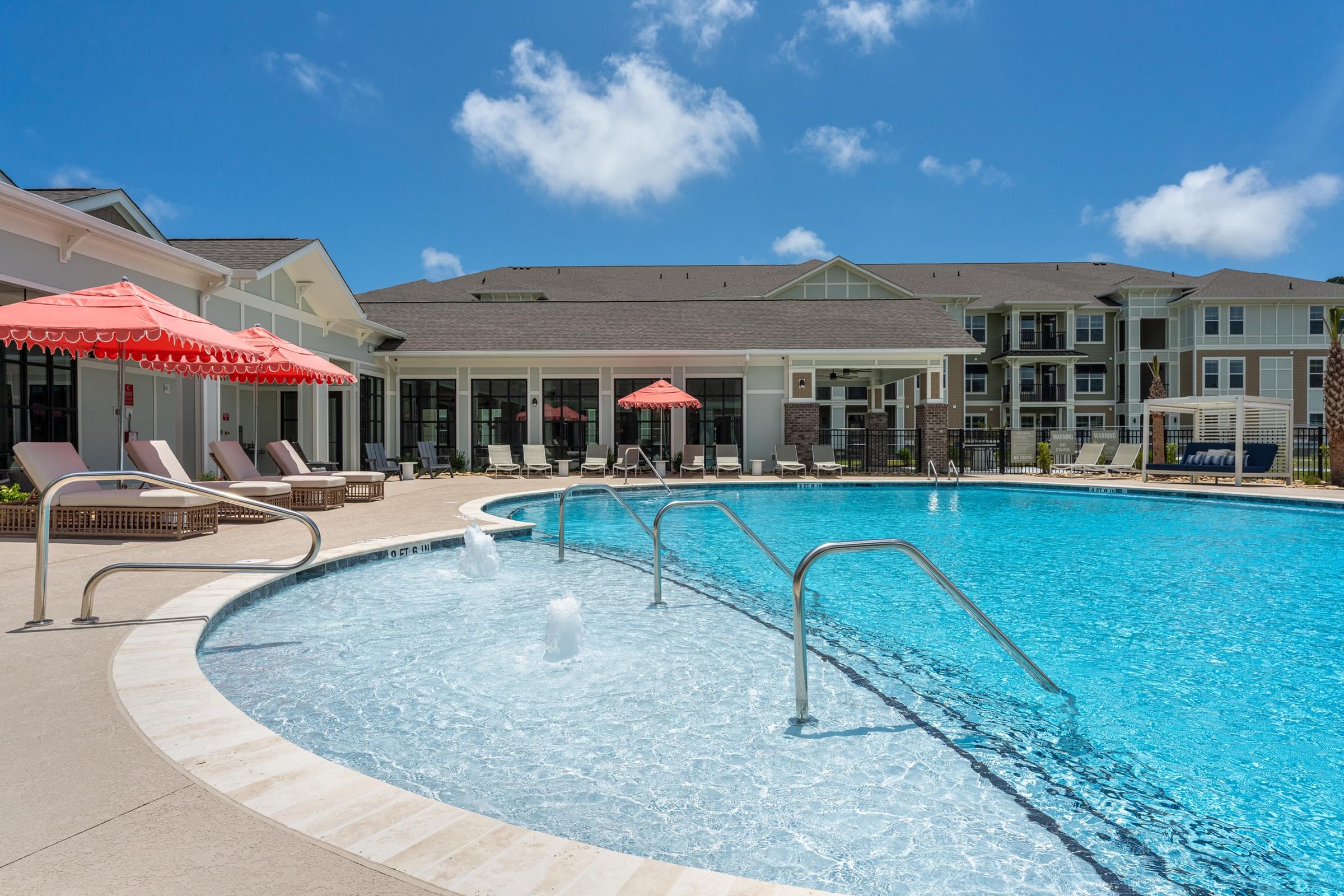 A swimming pool with a fountain in the middle of it.