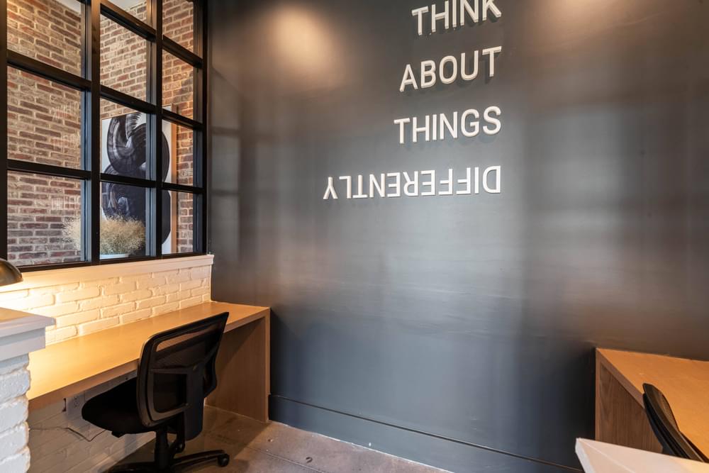 a room with a desk and a window with the words think about things and a