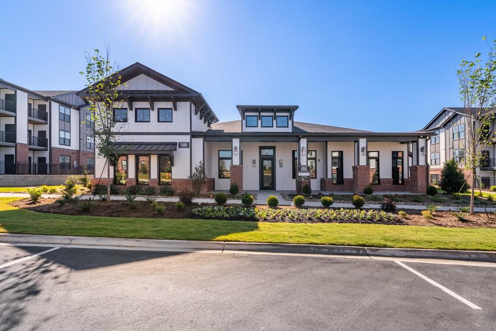 a large house with a lawn and a parking lot