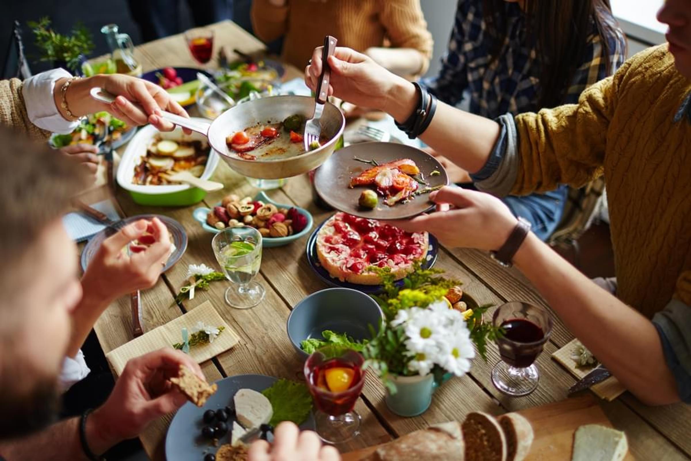 A group of people enjoying a meal together at a table.