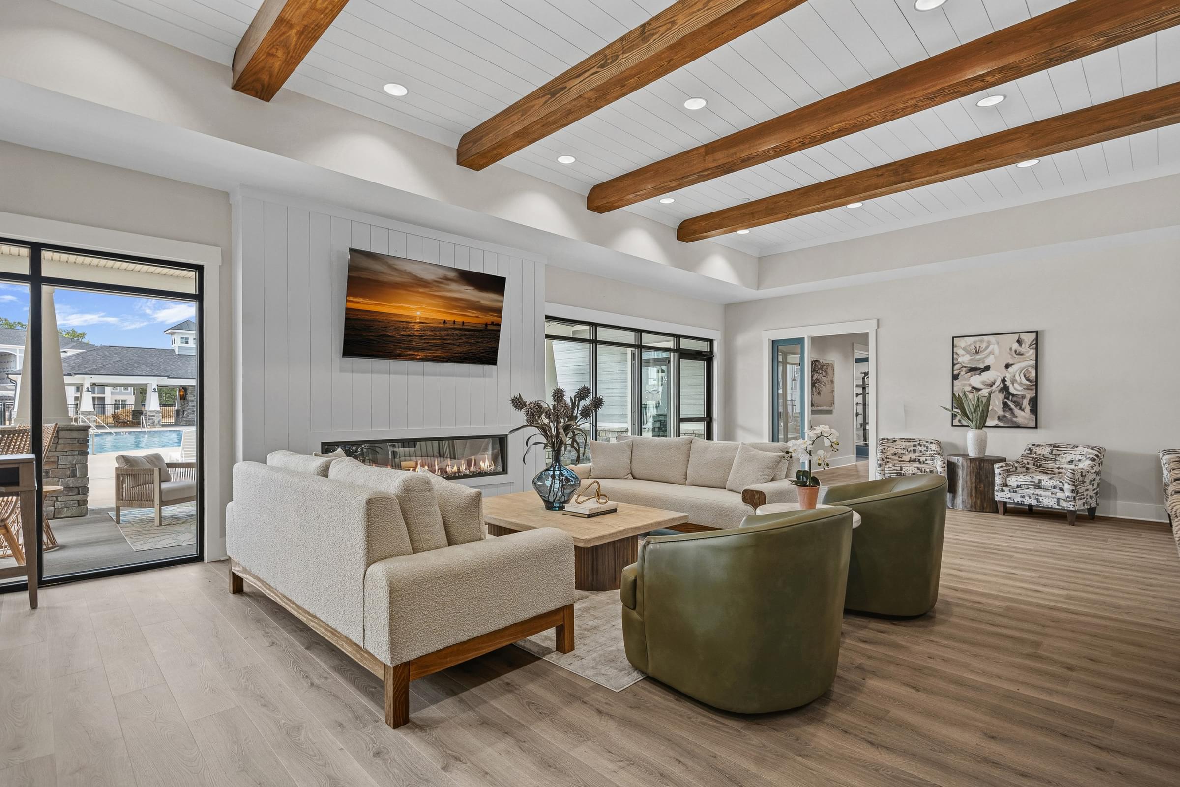 A modern living room with a large painting on the wall and a fireplace.