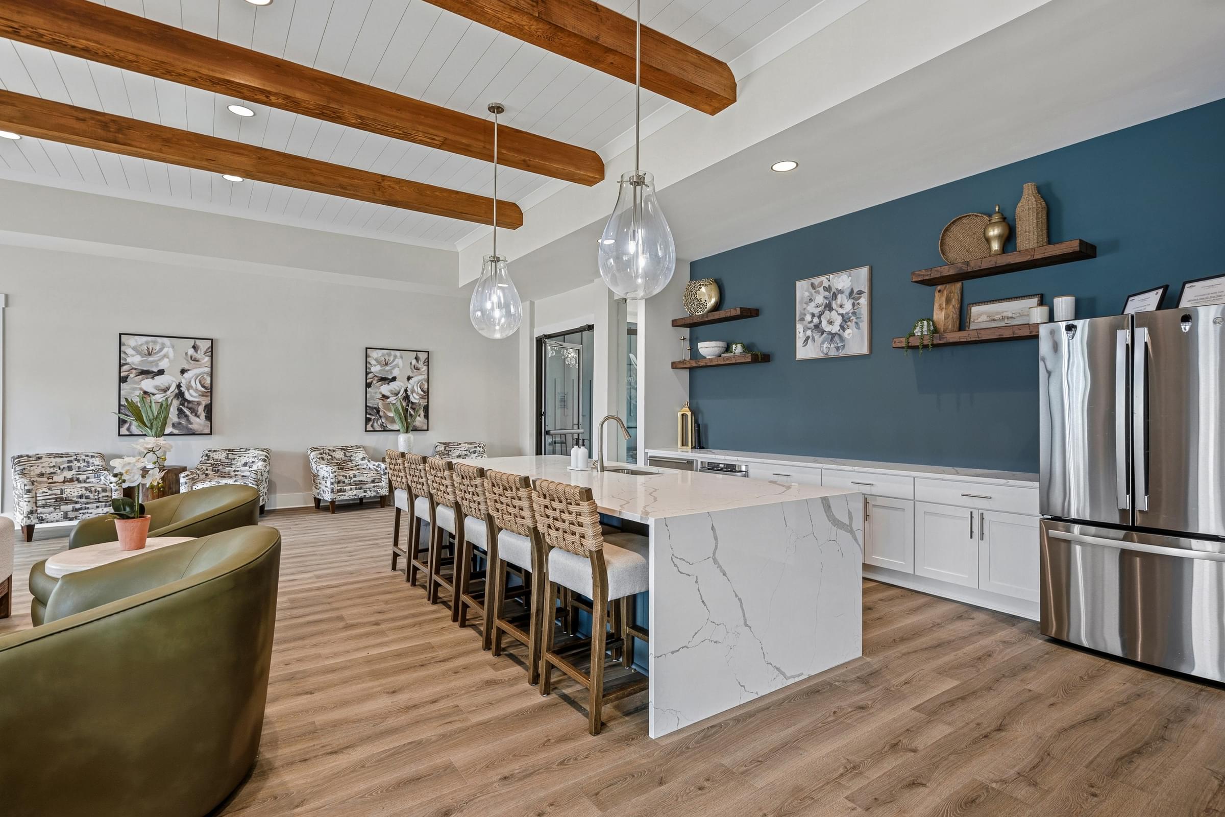 A modern kitchen with a long island and chairs.