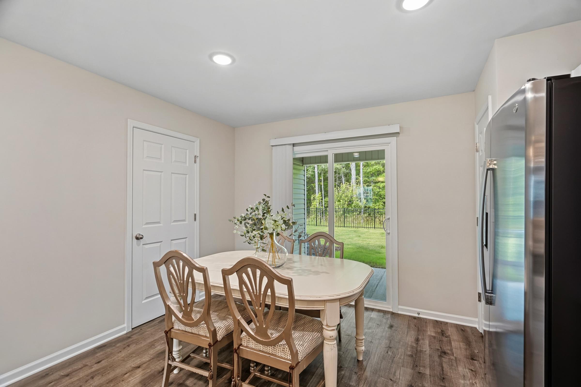 A dining room with a table and chairs.