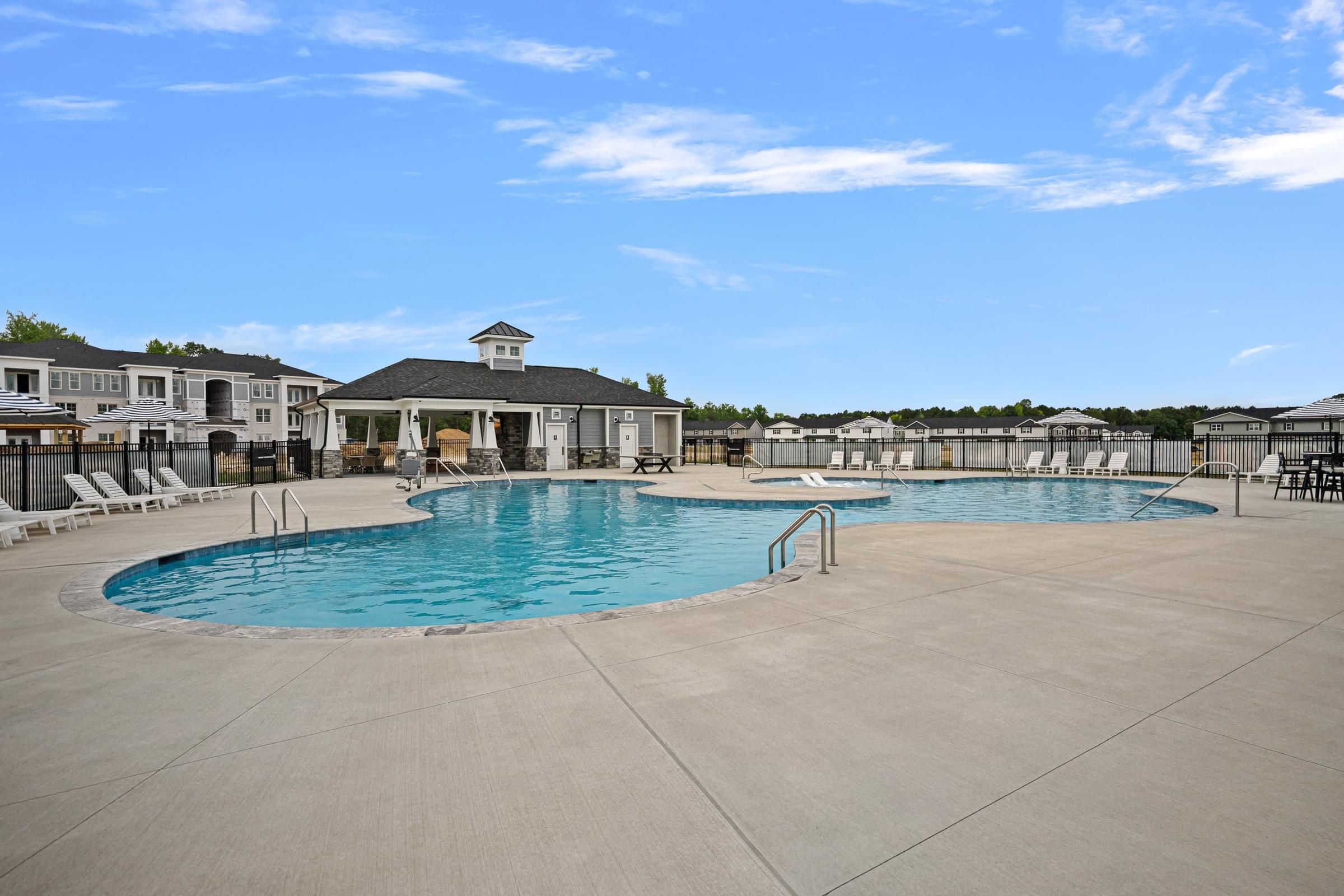A large outdoor pool with a gazebo in the background.