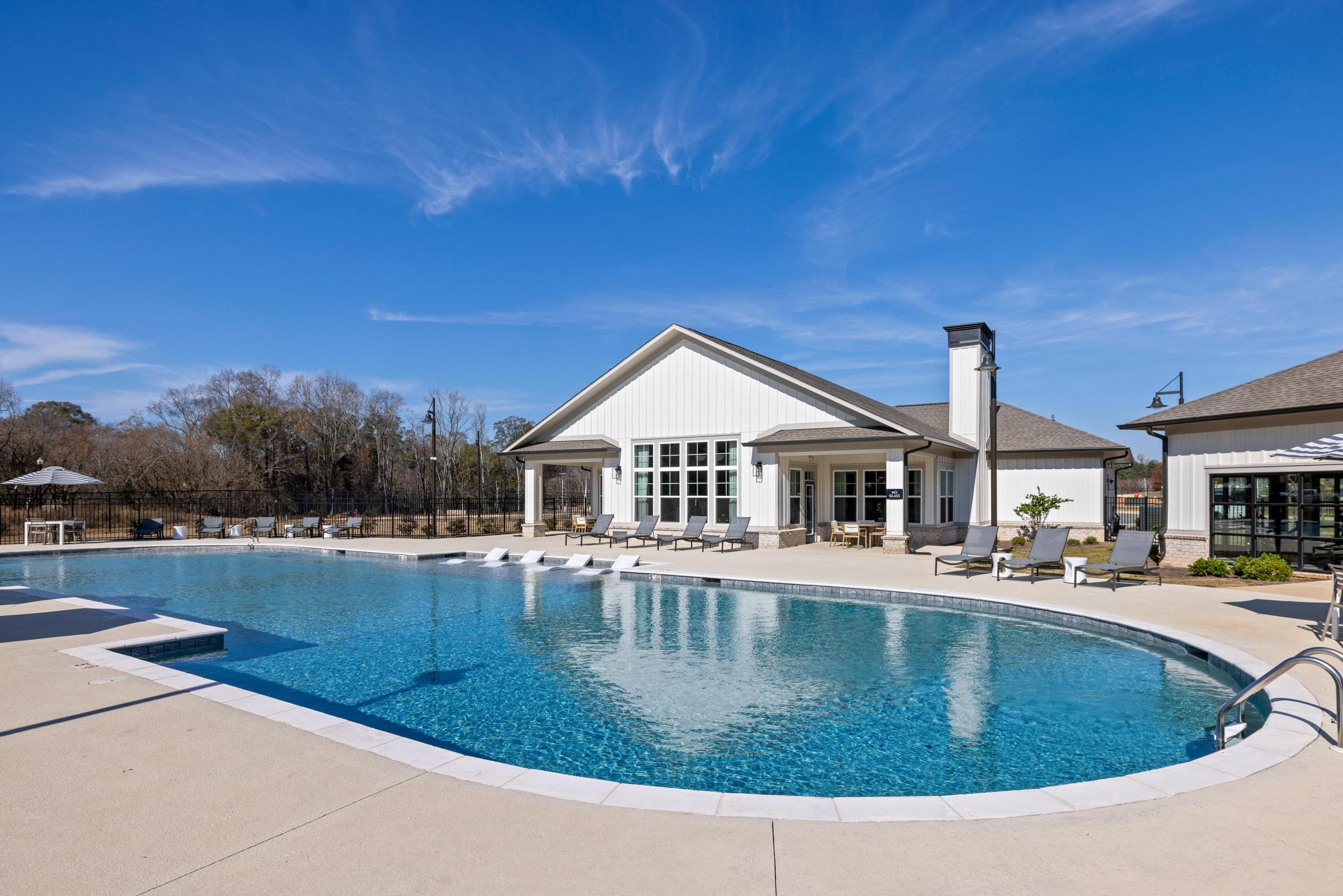 A large house with a pool in the backyard.