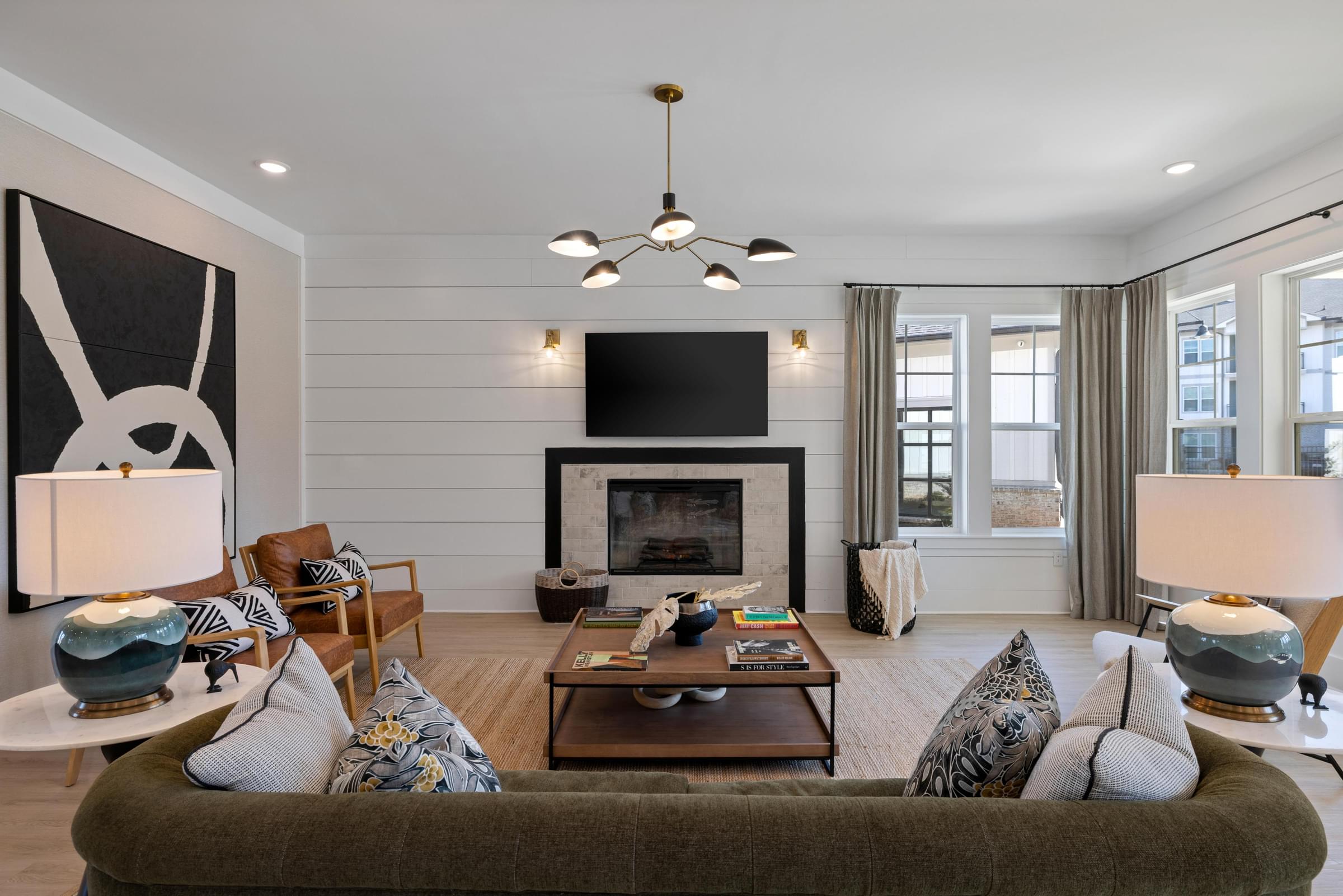 A living room with a fireplace and a television.