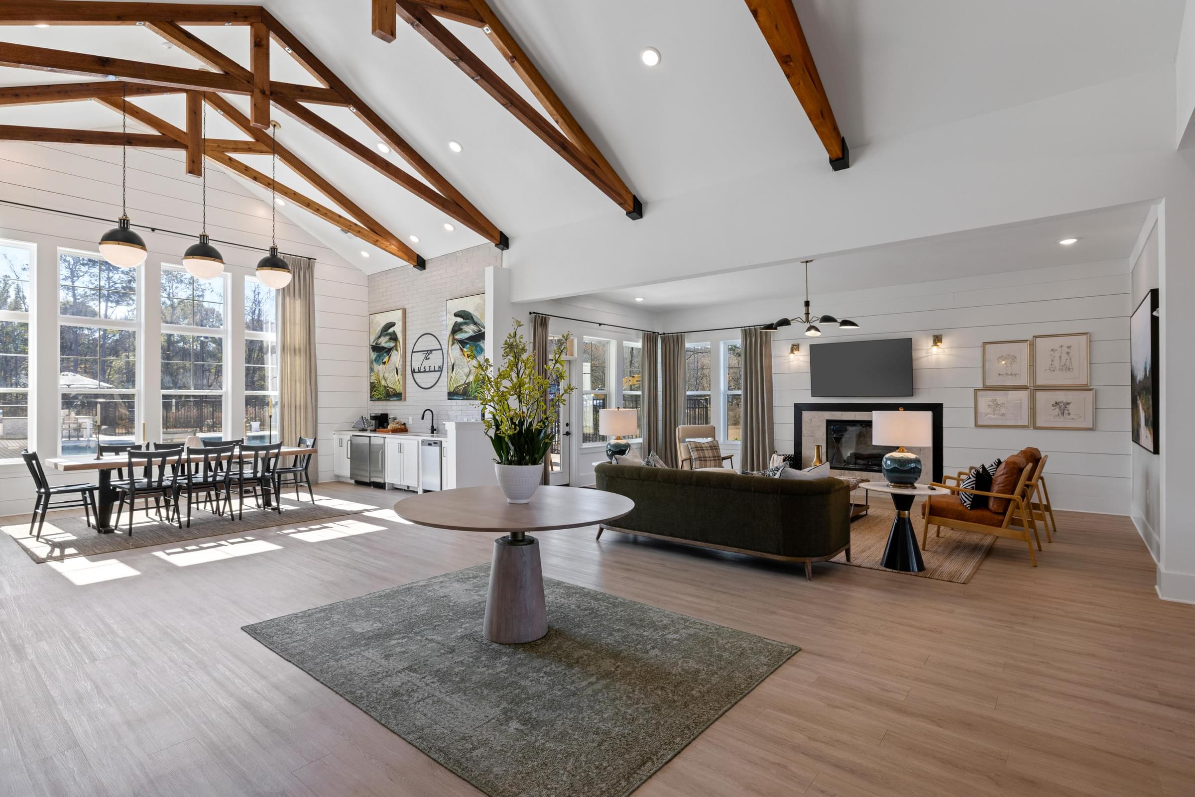A modern living room with a large window and a fireplace.